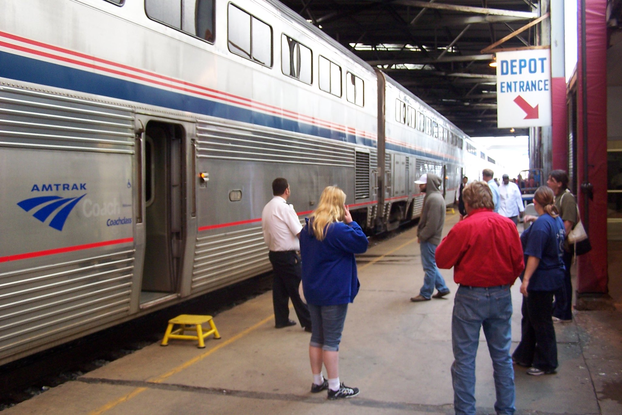 Travelers wait on the platform of the Amtrak station in Milwaukee, Wis.