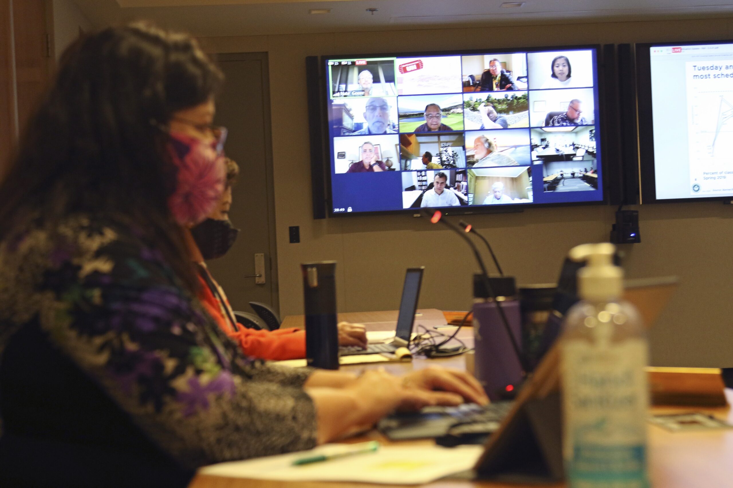 University of Hawaii staffers monitor a livestreamed Zoom meeting