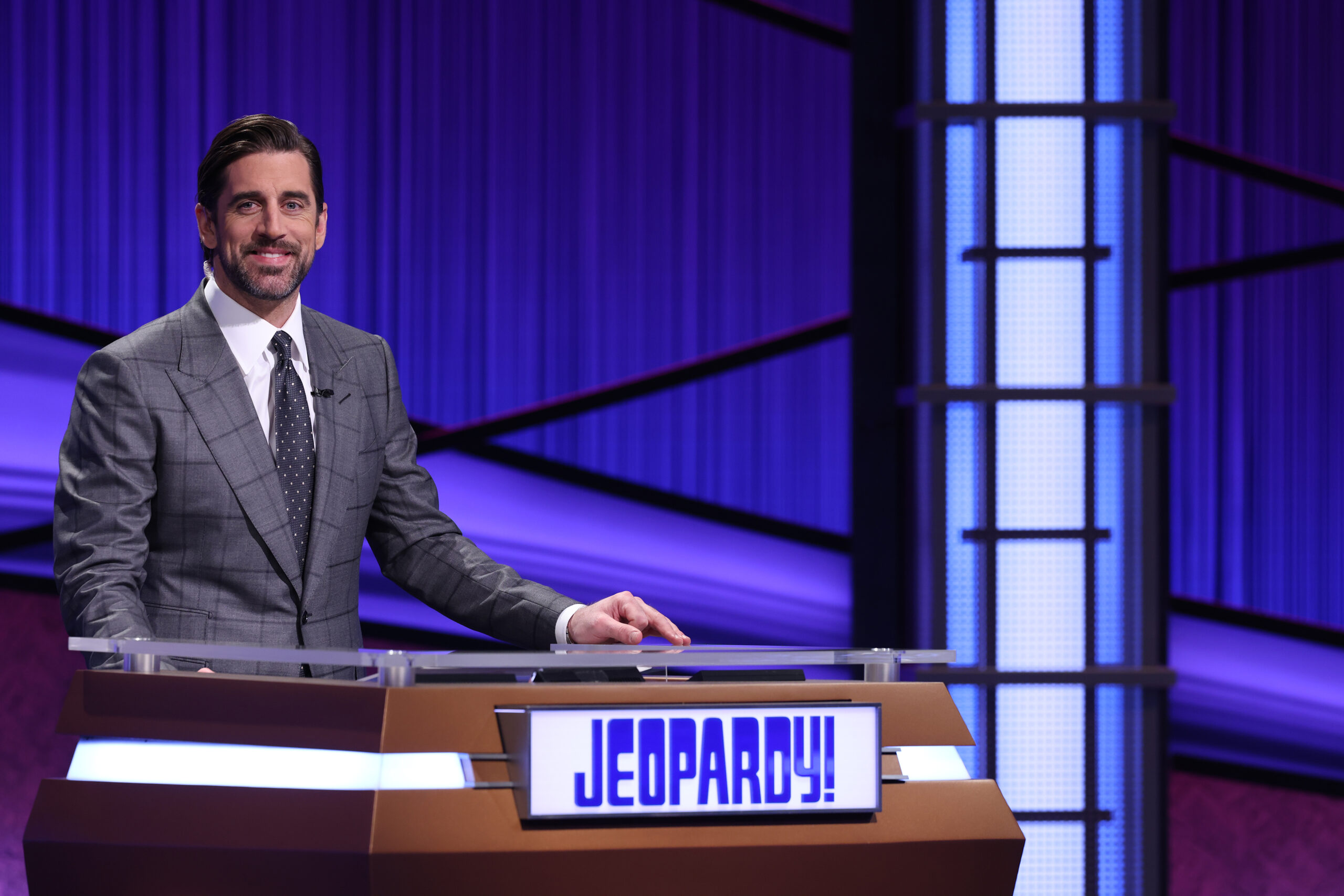Aaron Rodgers poses behind the host desk at "Jeopardy!"