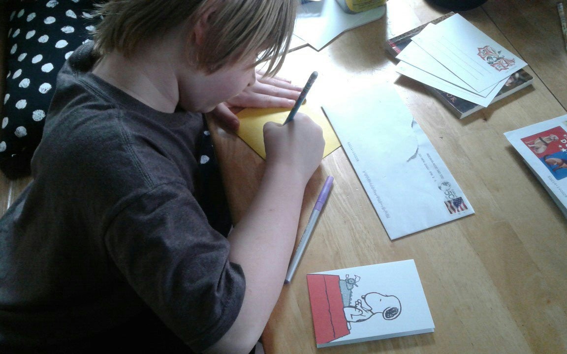 Lachlan Hofschulte addresses a letter.