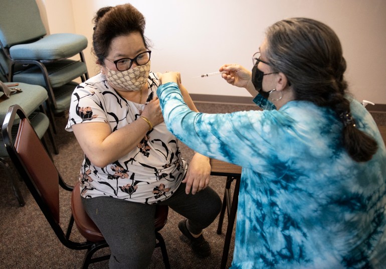 Madison resident Chia Yang, 56, gets her first dose of the Moderna vaccine at a clinic put on by The Hmong Institute