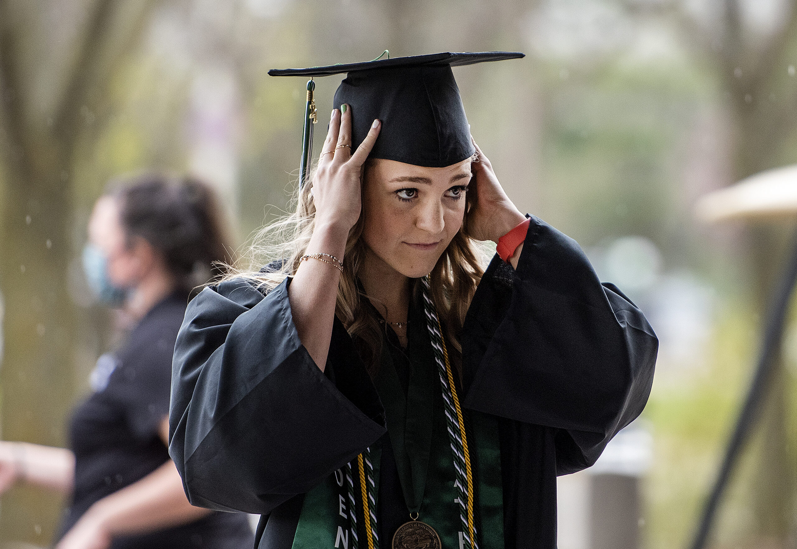 AUW-Green Bay graduate adjusts her cap