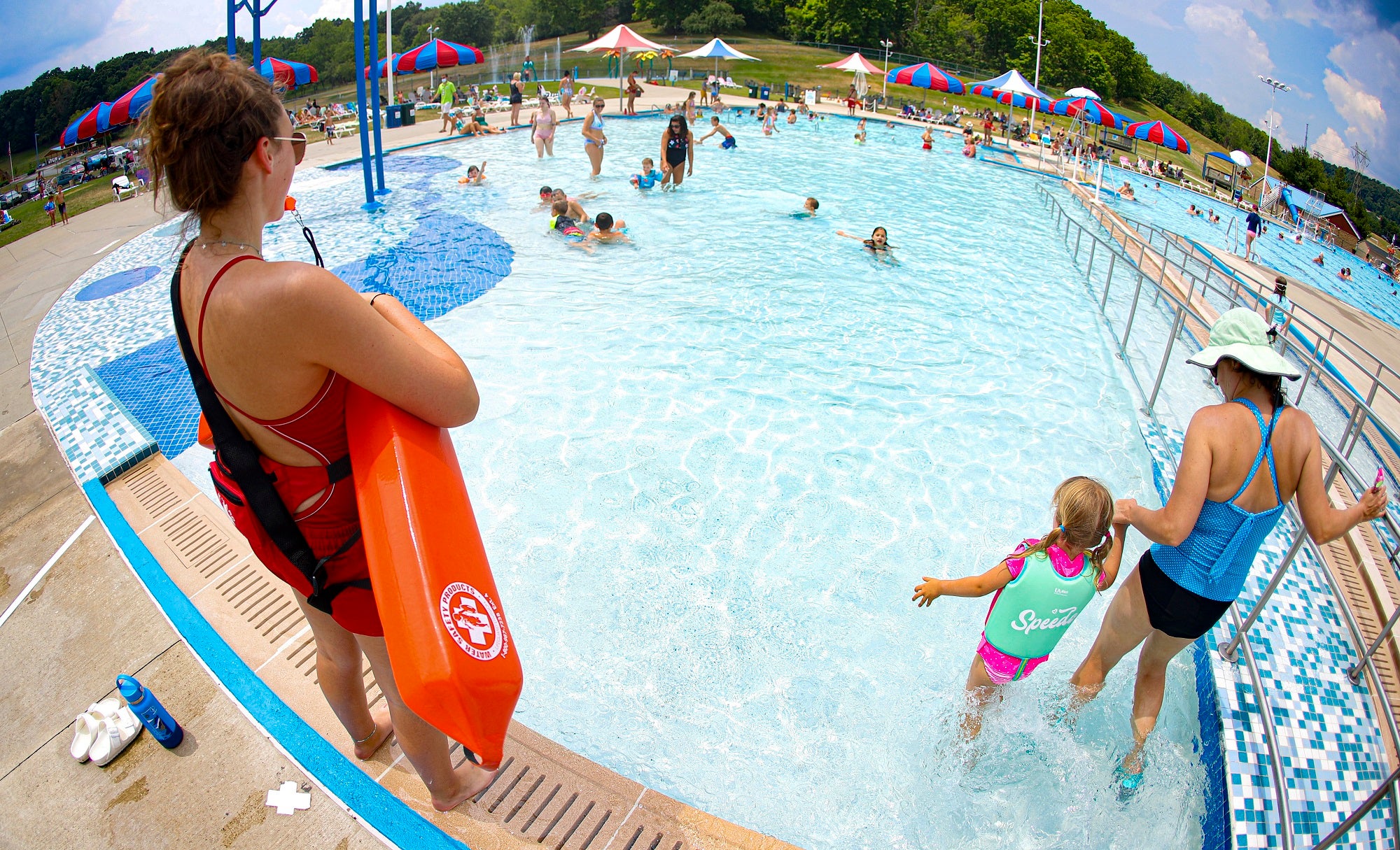 A lifeguard watches over a public pool