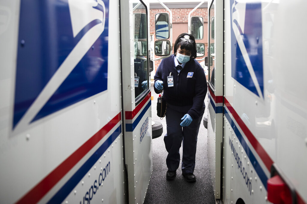 United States Postal Service carrier Henrietta Dixon gets into her truck