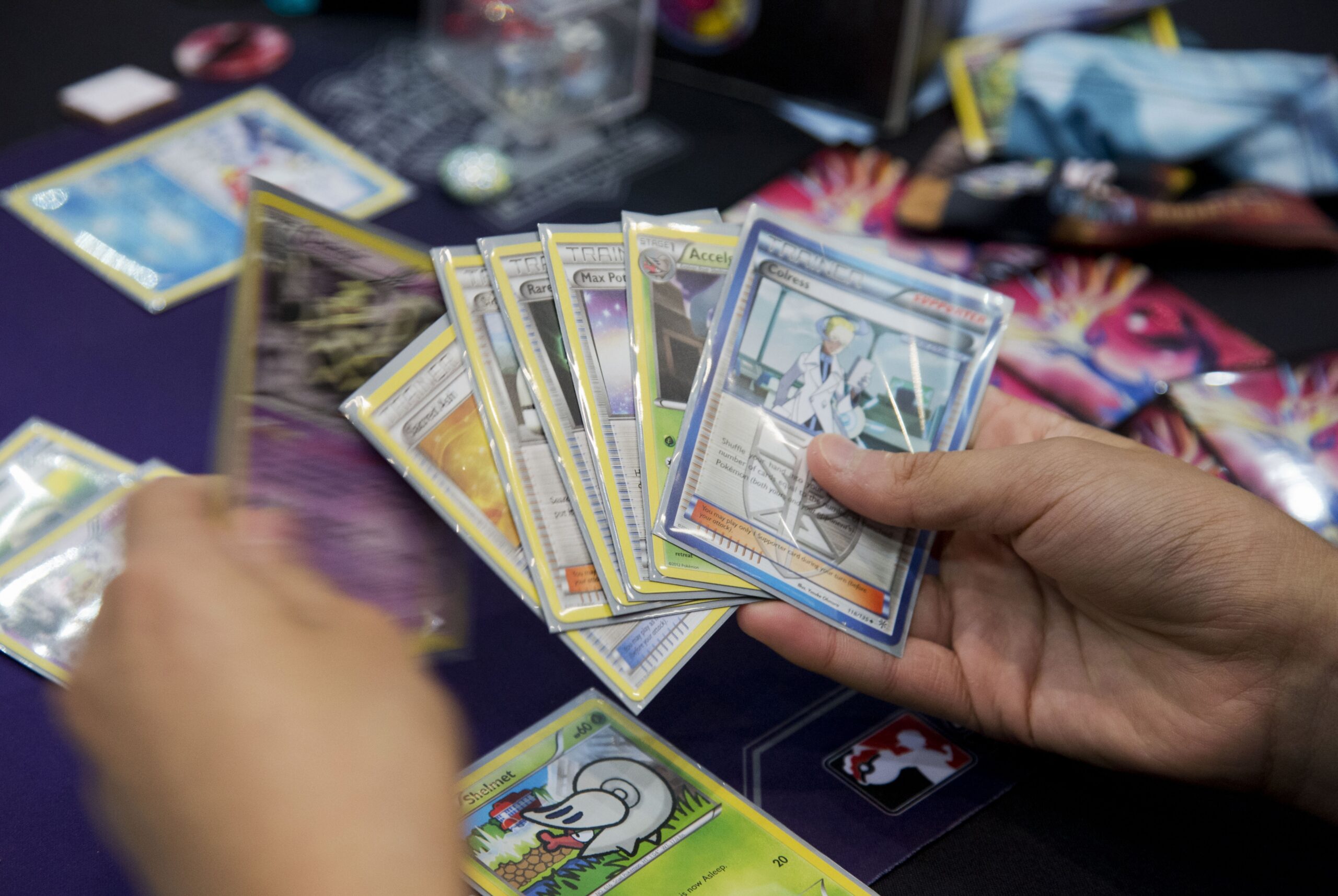 A player holds a deck of Pokemon cards during a competition