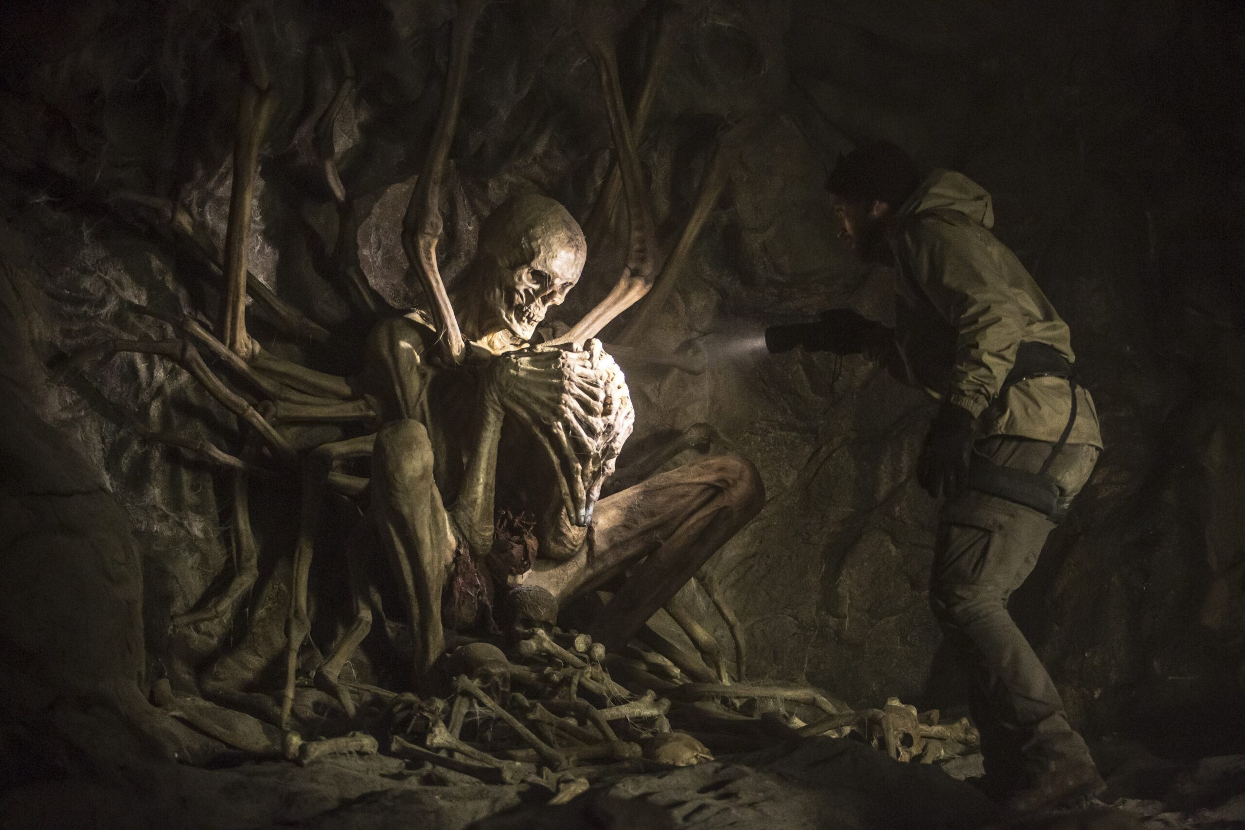 Character discovering skeleton in cave in promotional still from "The Empty Man"