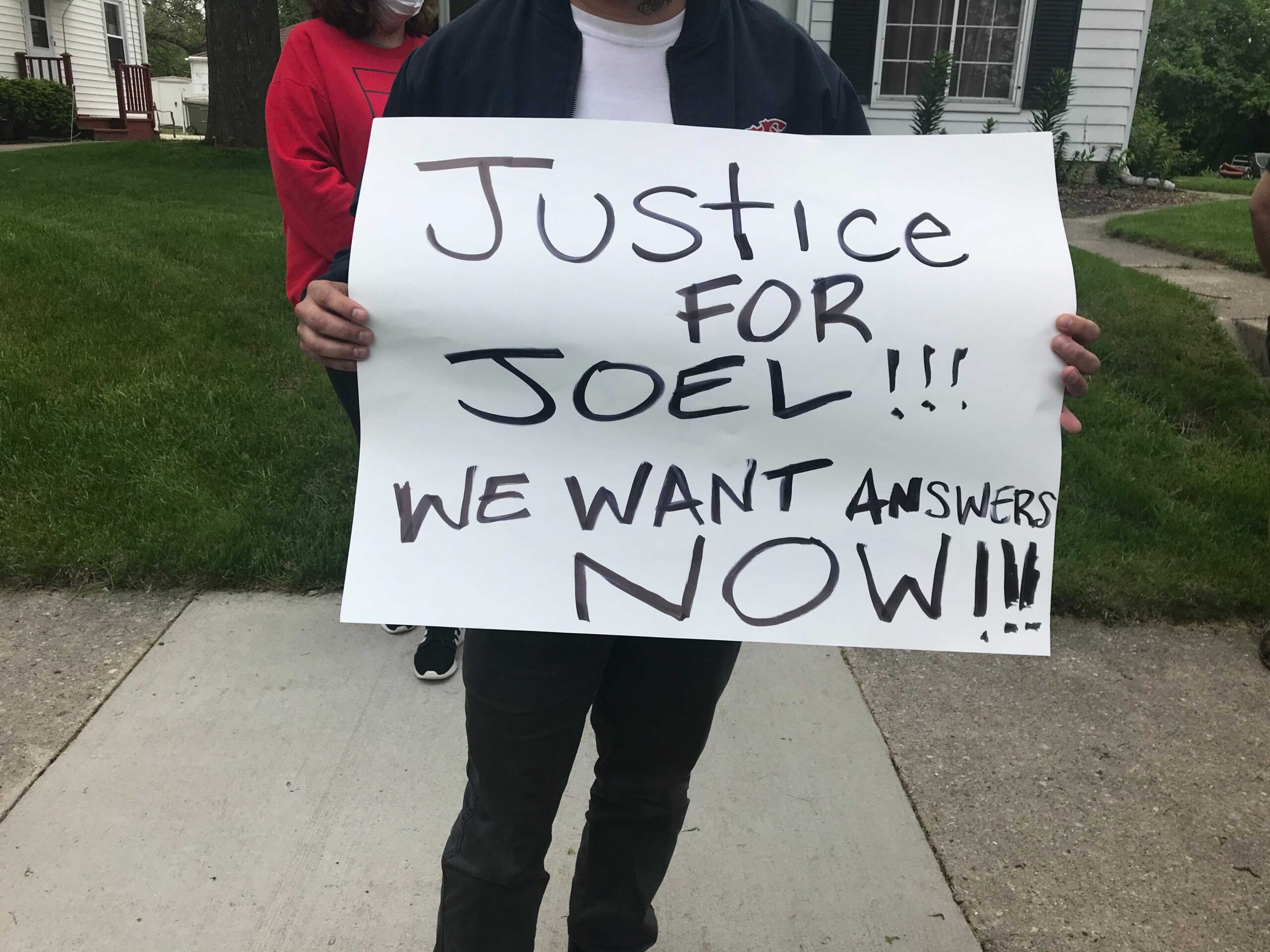 People gathered outside of Milwaukee police officer Michael Mattioli's home after the killing of Joel Acevedo