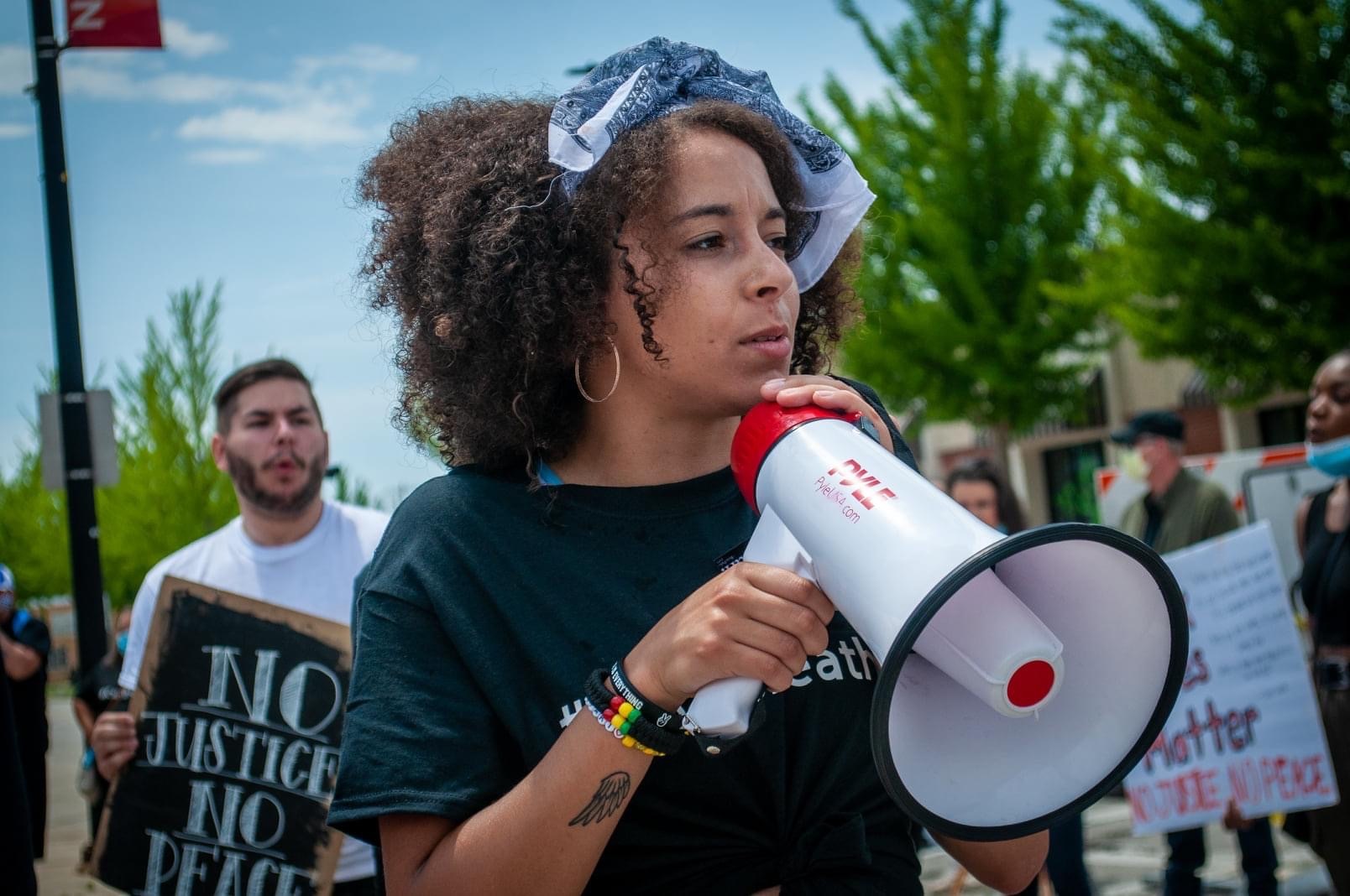 Hannah Beauchamp-Pope speaks into a megaphone during a June 2020 protest