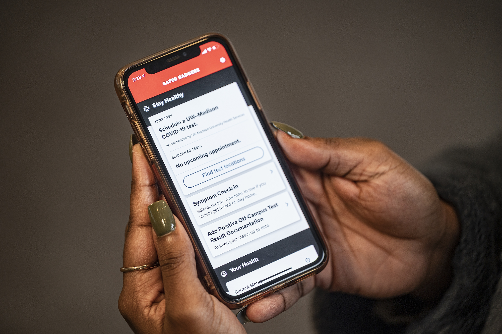 UW-Madison student Kingsley Pissang uses the Safer Badgers phone app to schedule a COVID-19 saliva test 