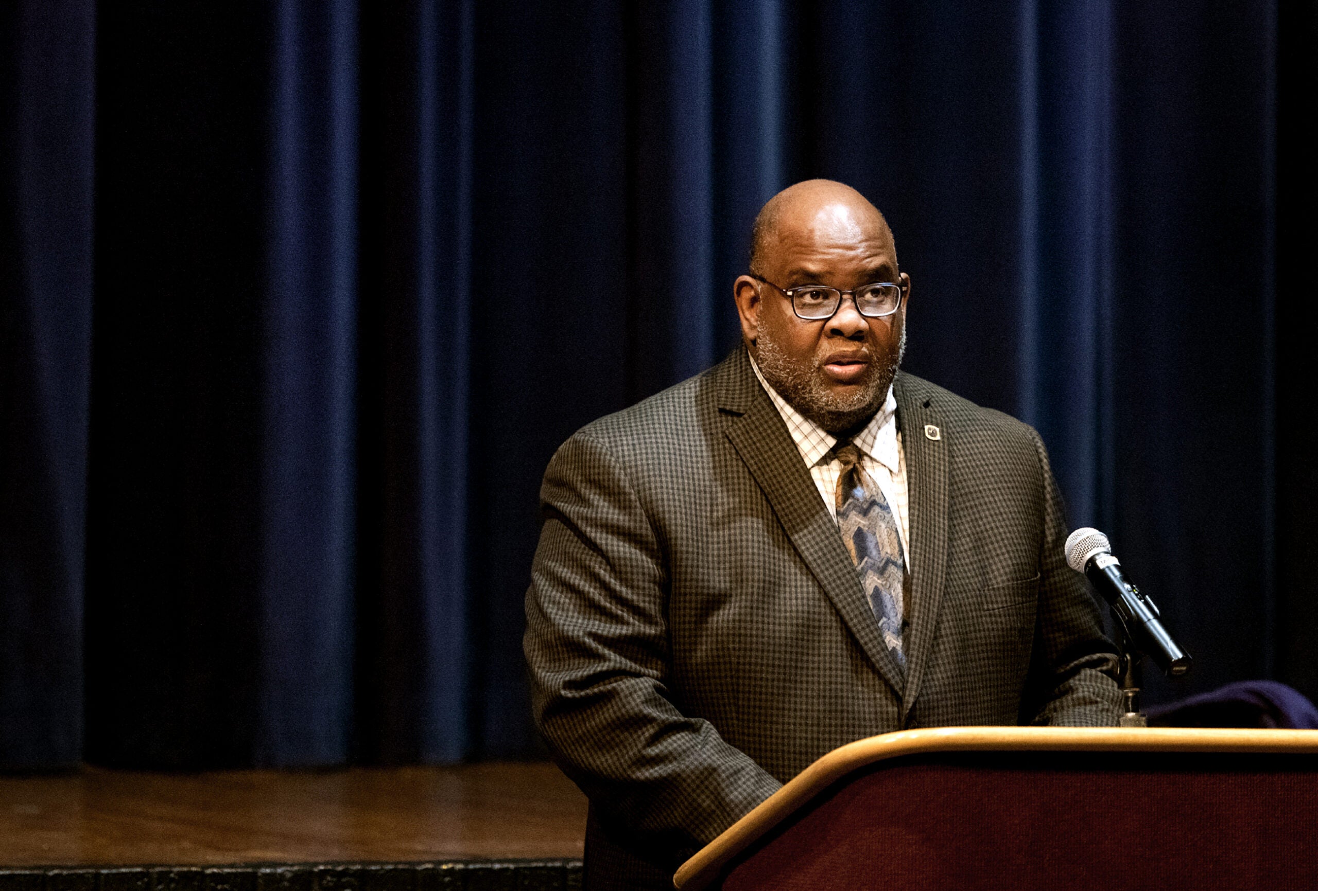 Dwight Watson speaks at a podium.