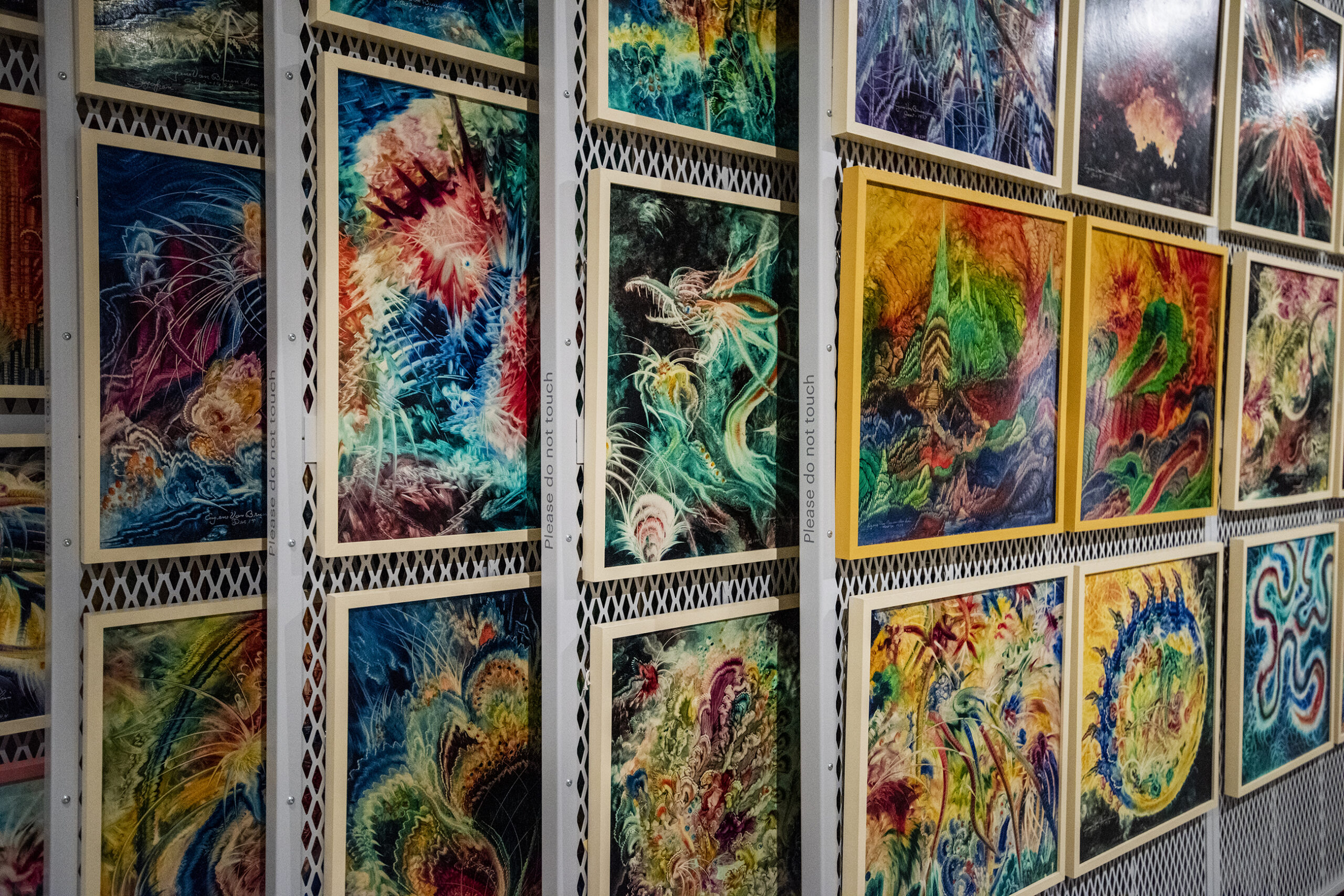 Colorful paintings are displayed on several different panels.