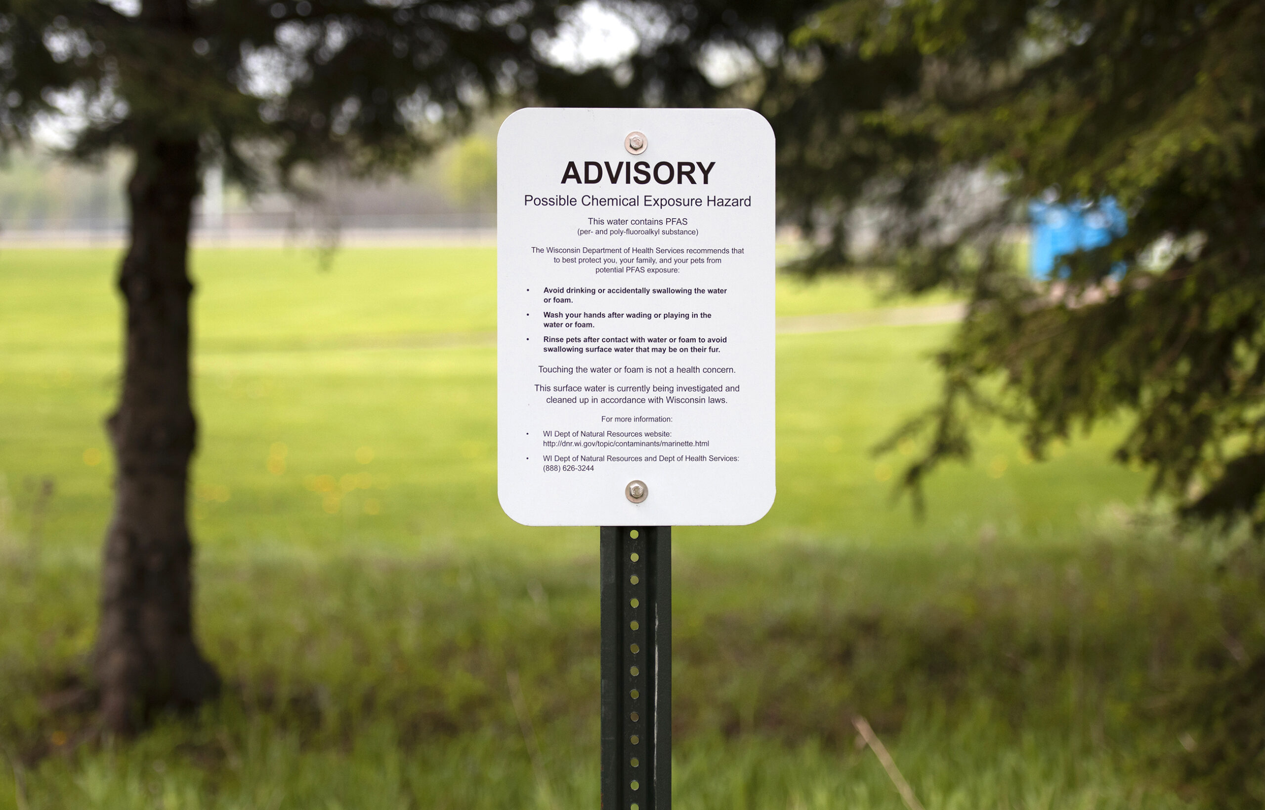 A sign says "ADVISORY" in large letters. The rest of the text warns people about PFAS in the water.