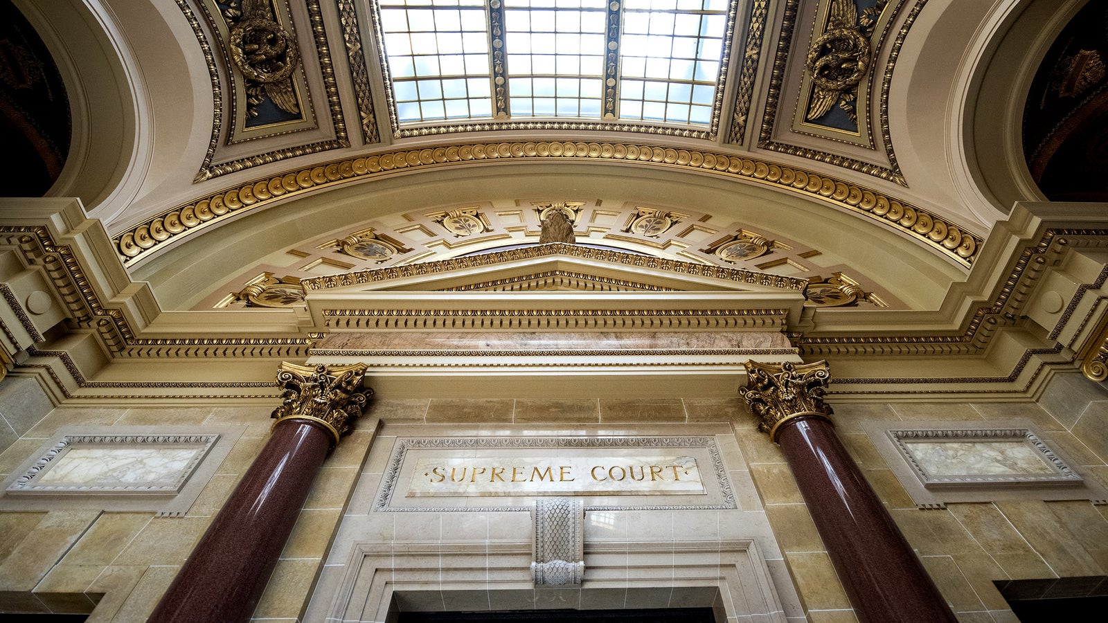 "Supreme Court" is written above a door inside the Wisconsin State Capitol.
