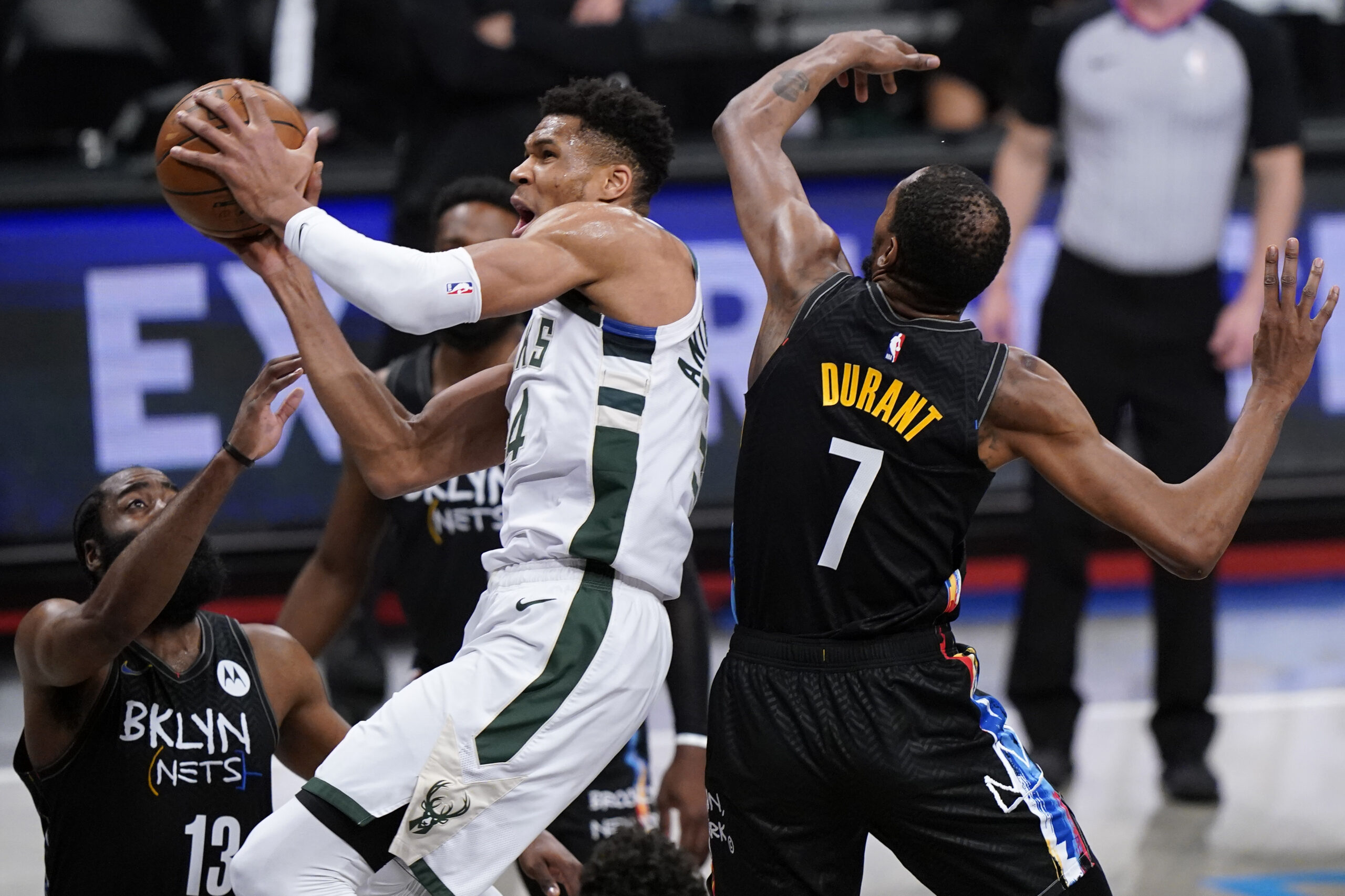 Nets' James Harden and Kevin Durant try to contain Bucks forward Giannis Antetokounmpo