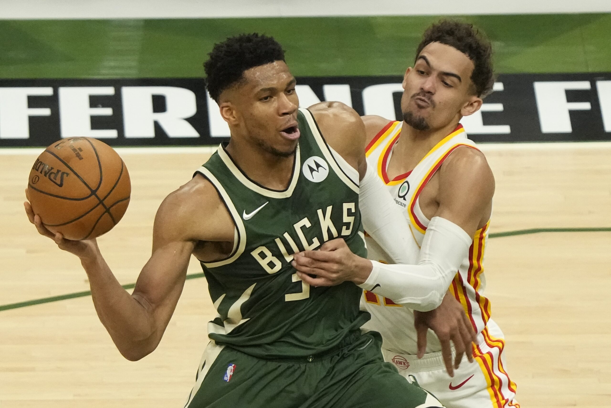 Giannis Antetokounmpo tries to get past Trae Young in Game 1 of the NBA's 2021 Eastern Conference finals
