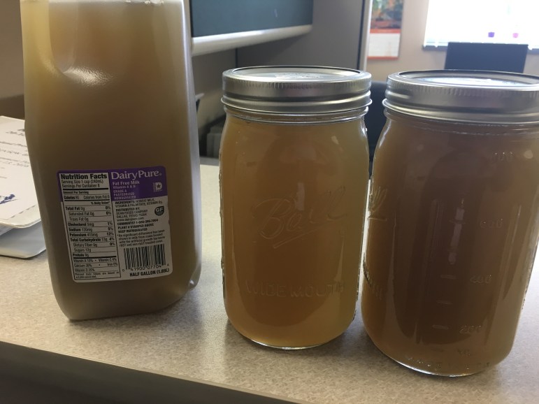 These jars contain brown water taken from a tap in Kewaunee County that researchers tied to spreading of manure