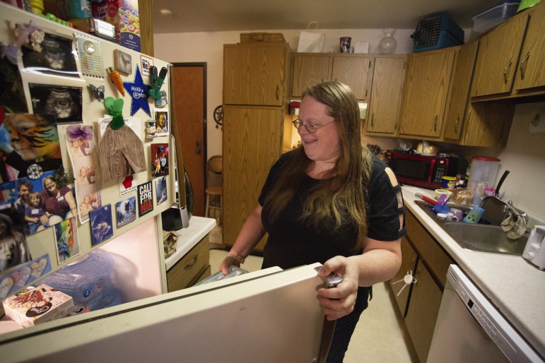 Molly Rodela, of Manitowoc, Wis., prepares dinner in her apartment