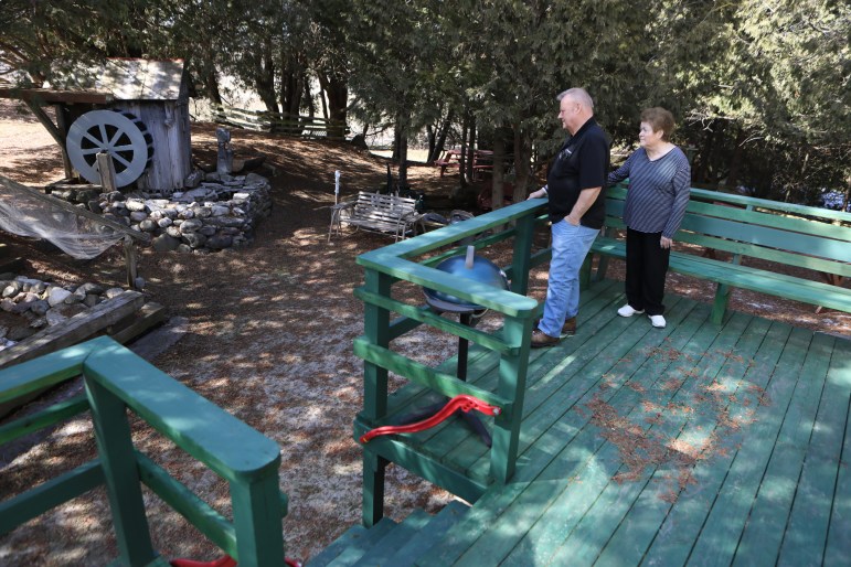 Arlin and Mary Lou Karnopp look over their backyard near Luxemburg