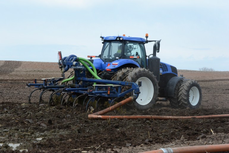 Manure is spread on a farm field during the Door-Kewaunee Watershed Demonstration Farms Networks Spring Field Day at Heims Hillcrest Dairy