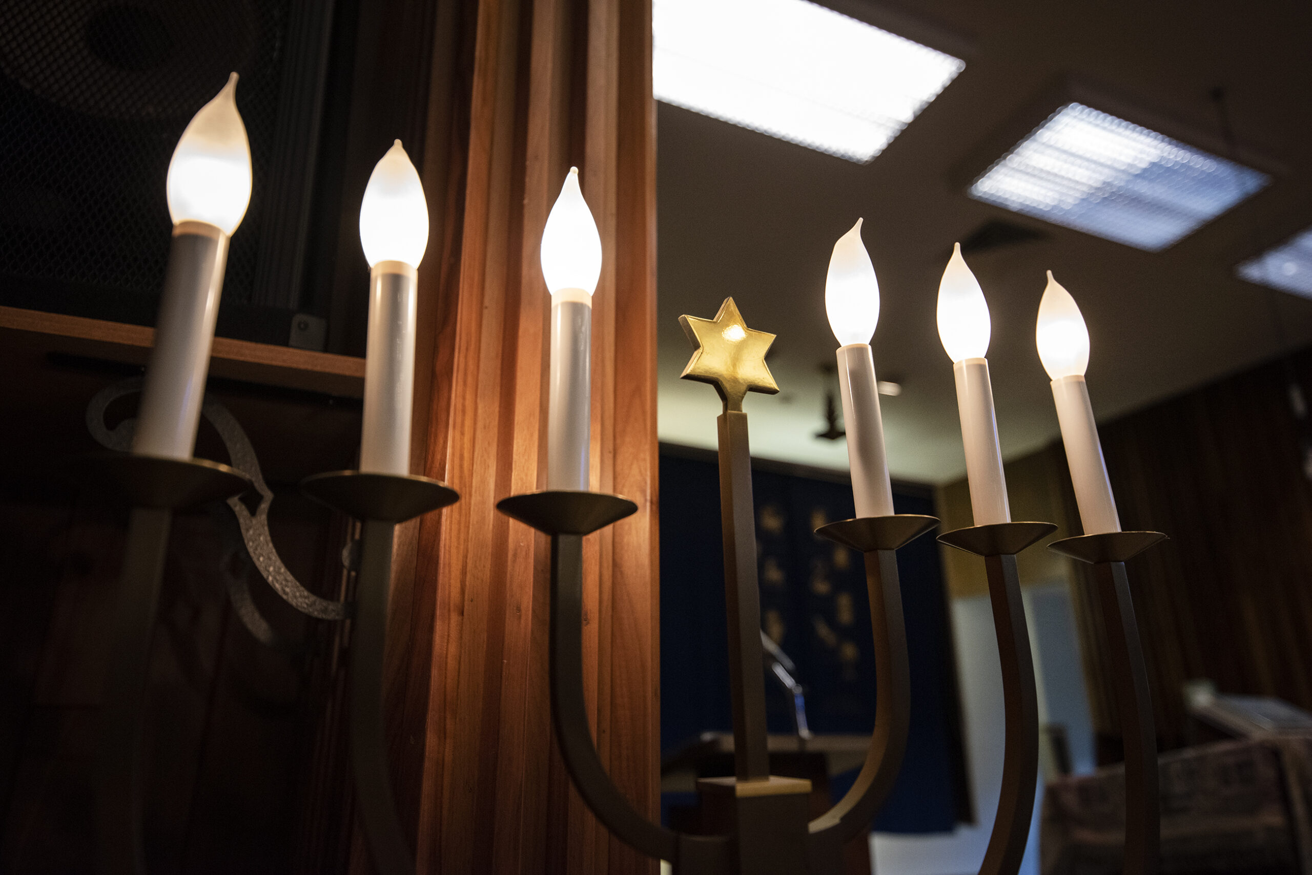 Lights on a menorah are turned on.