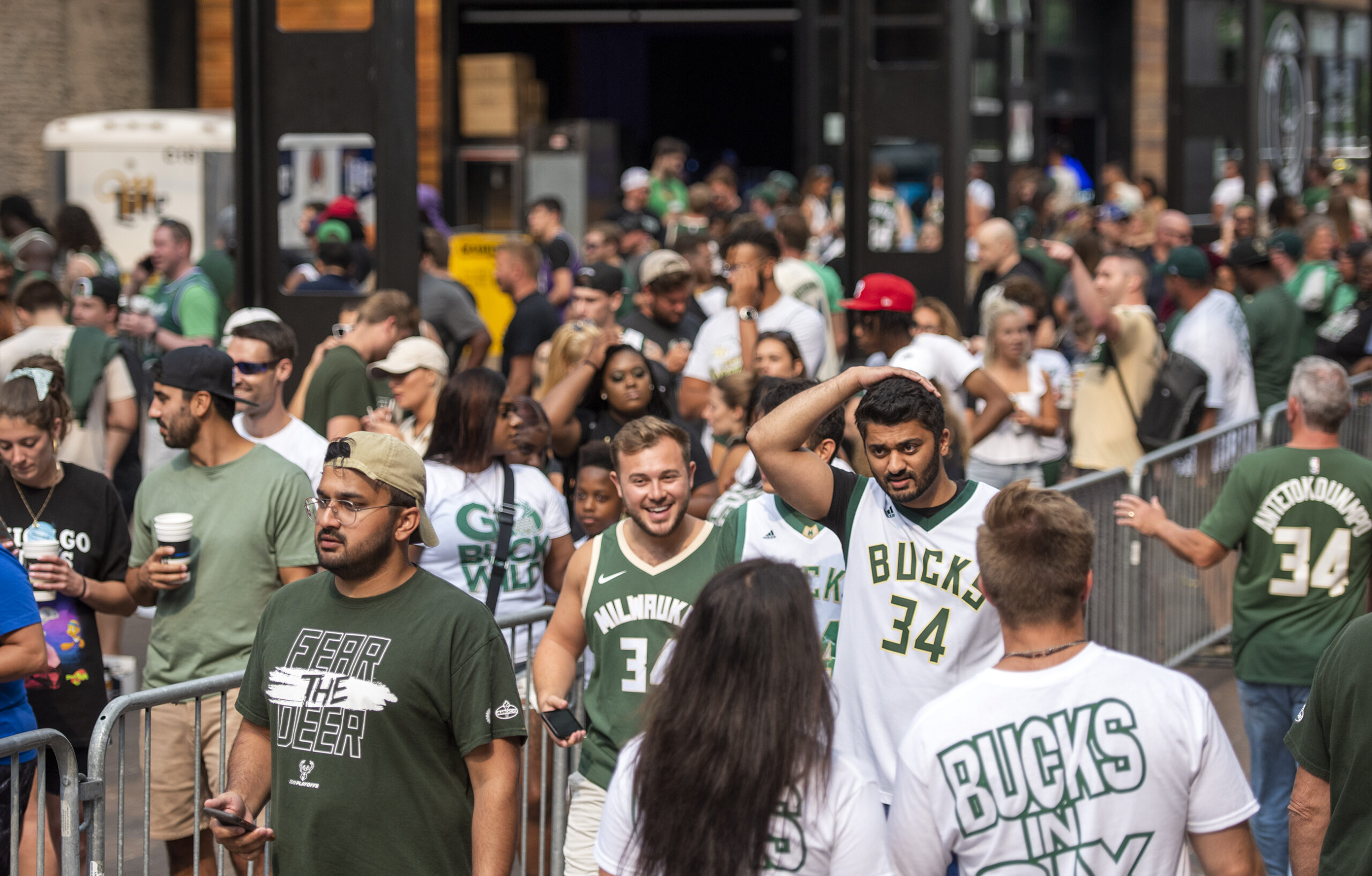 A crowd in Bucks t-shirts and jerseys gathers in the Deer District.