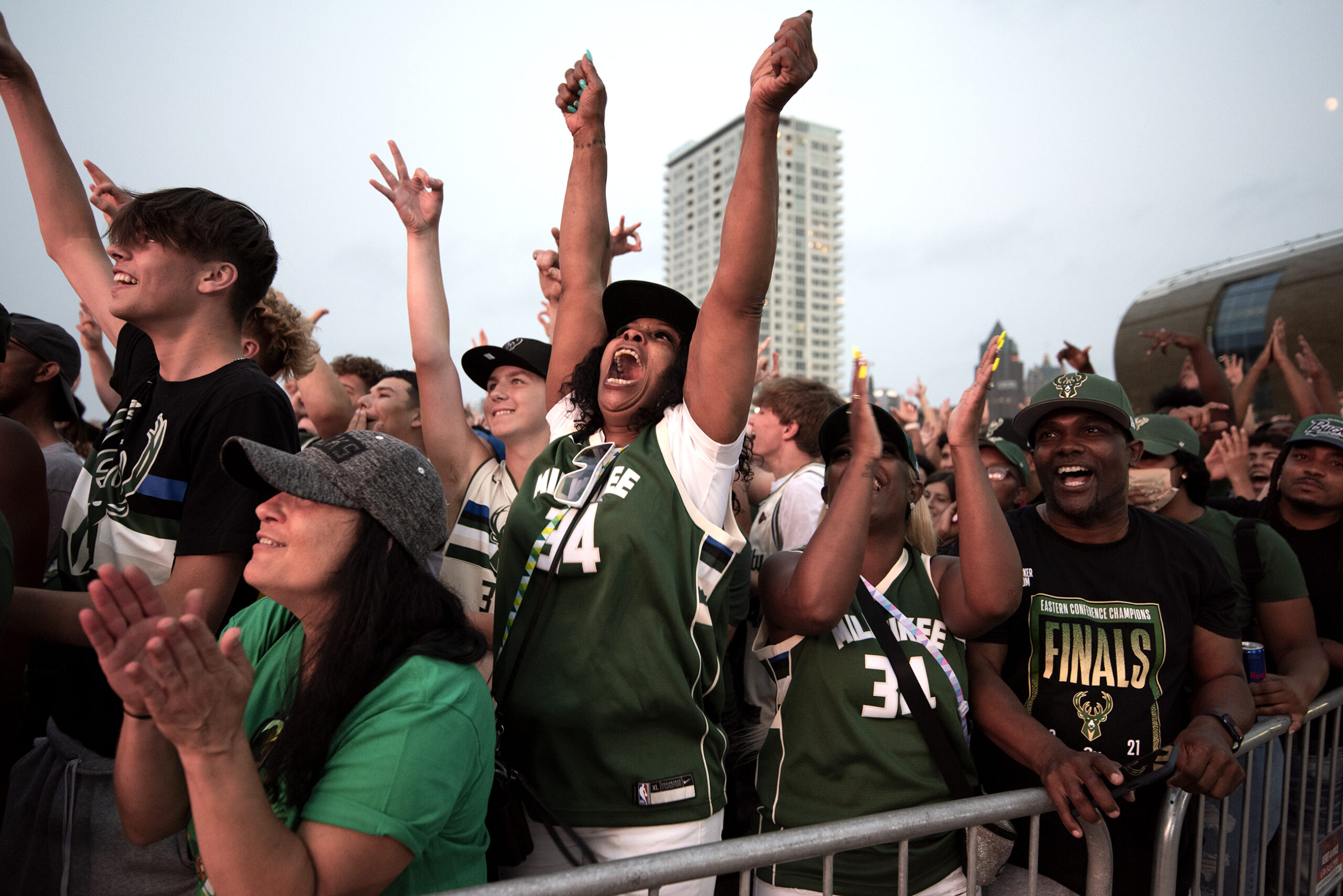 Bucks fans cheer in a crowd.