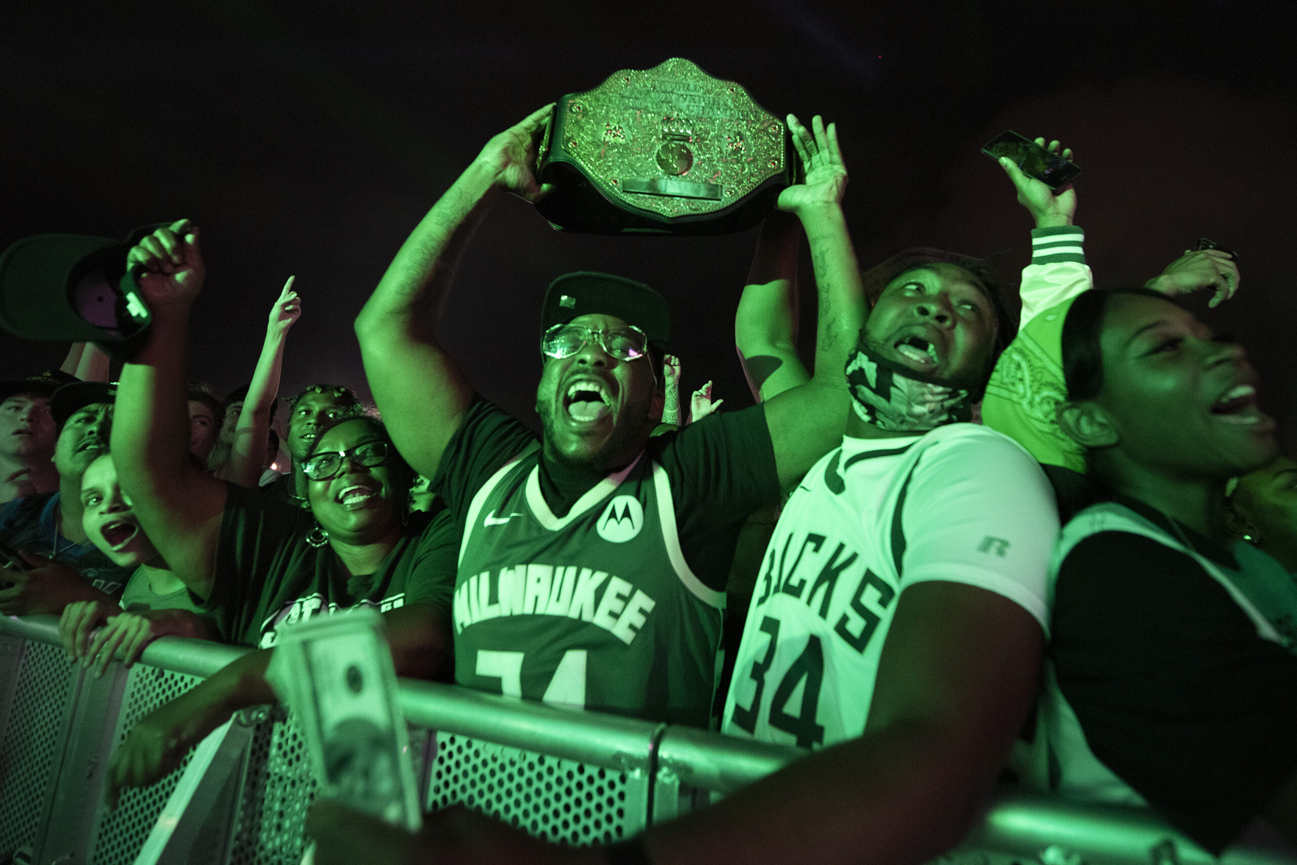 Bucks fans cheer in a crowd.