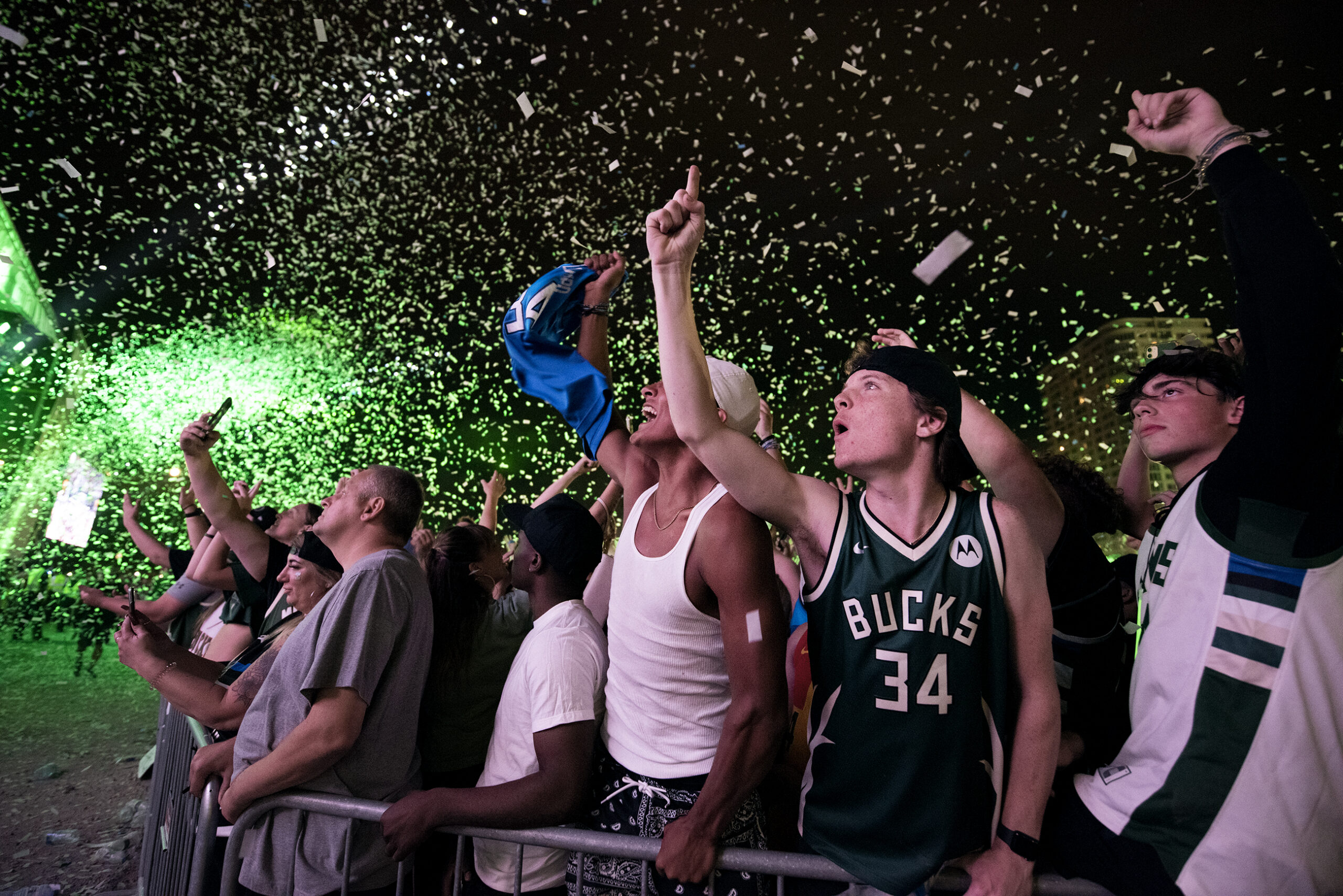 Bucks fans cheer in a crowd.