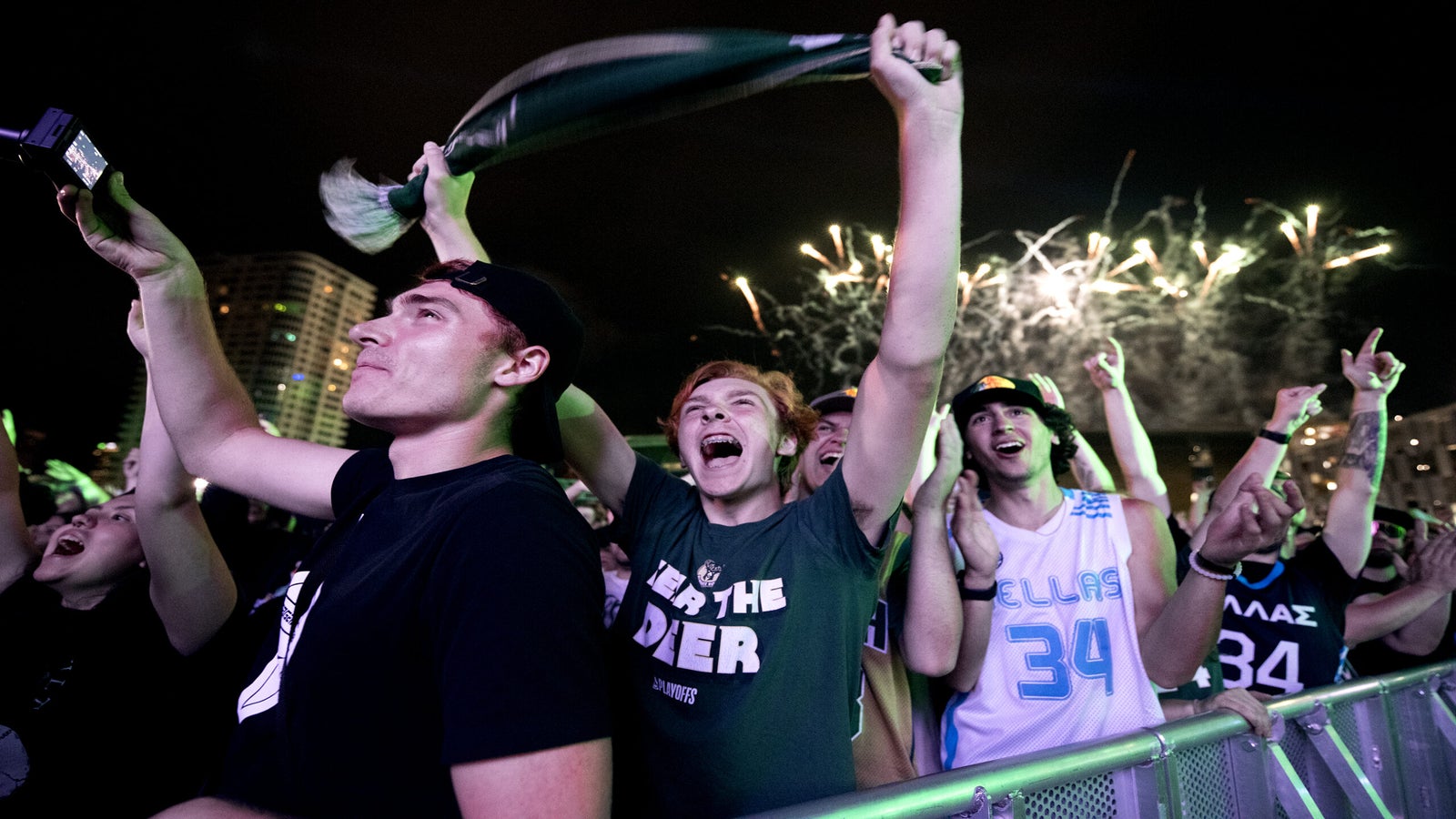 Bucks fans cheer in a crowd.