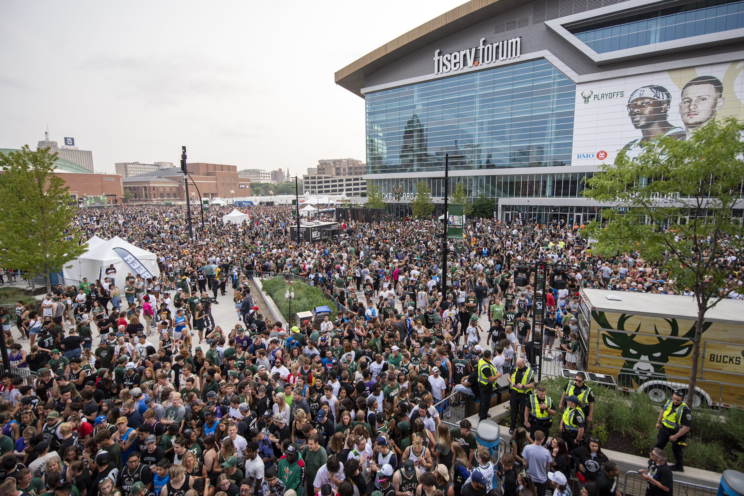 A sea of fans stands can be seen in front of the Fiserv Forum.