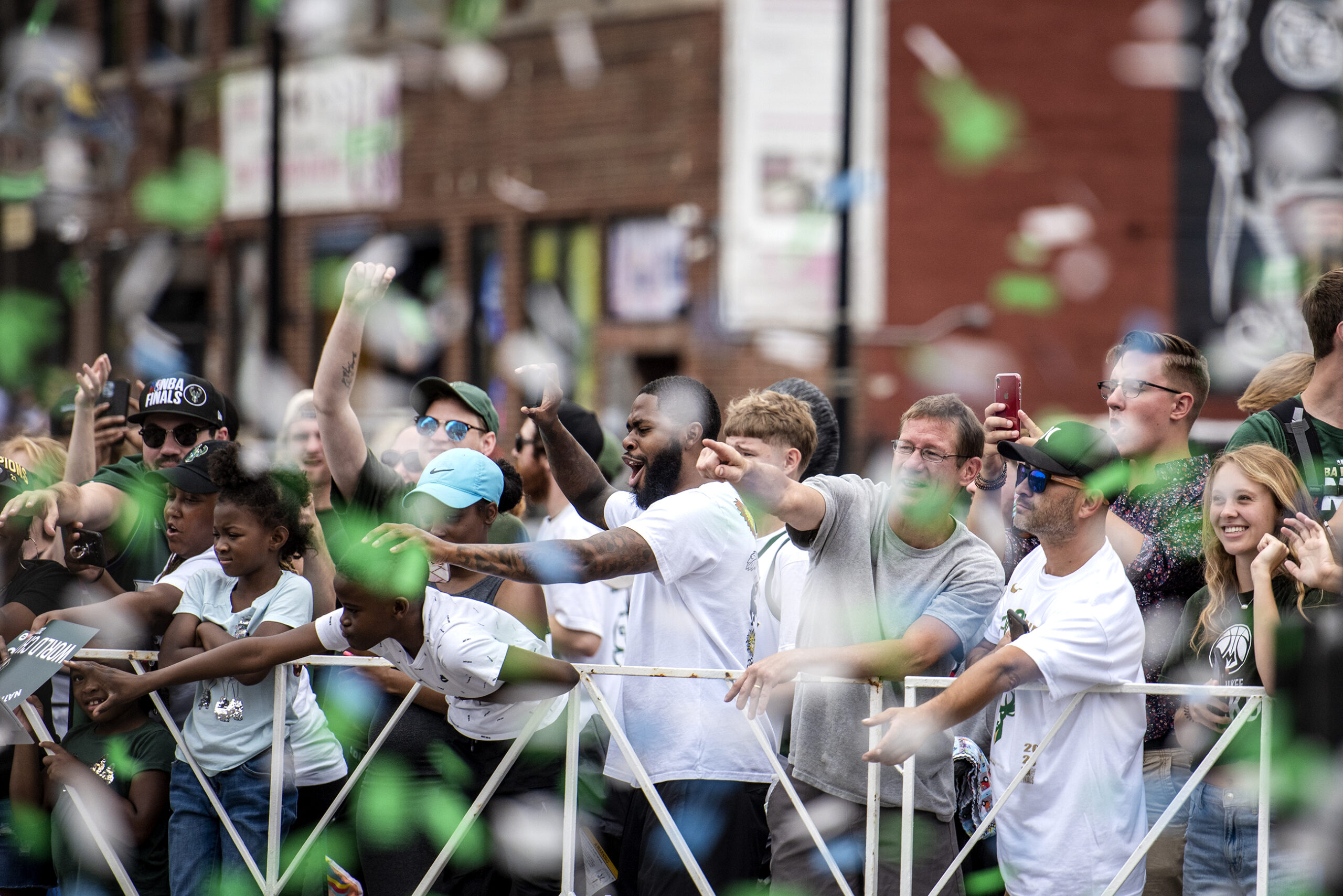 Green and white confetti fall on excited fans.