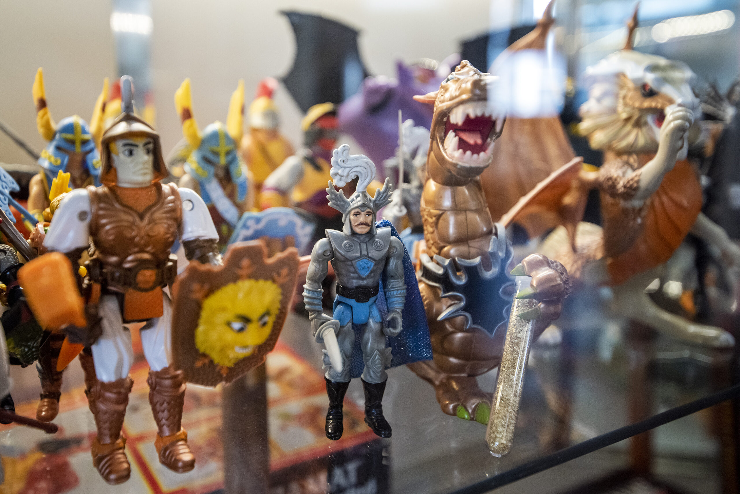 Colorful figurines depicting a man in armor and dragons.