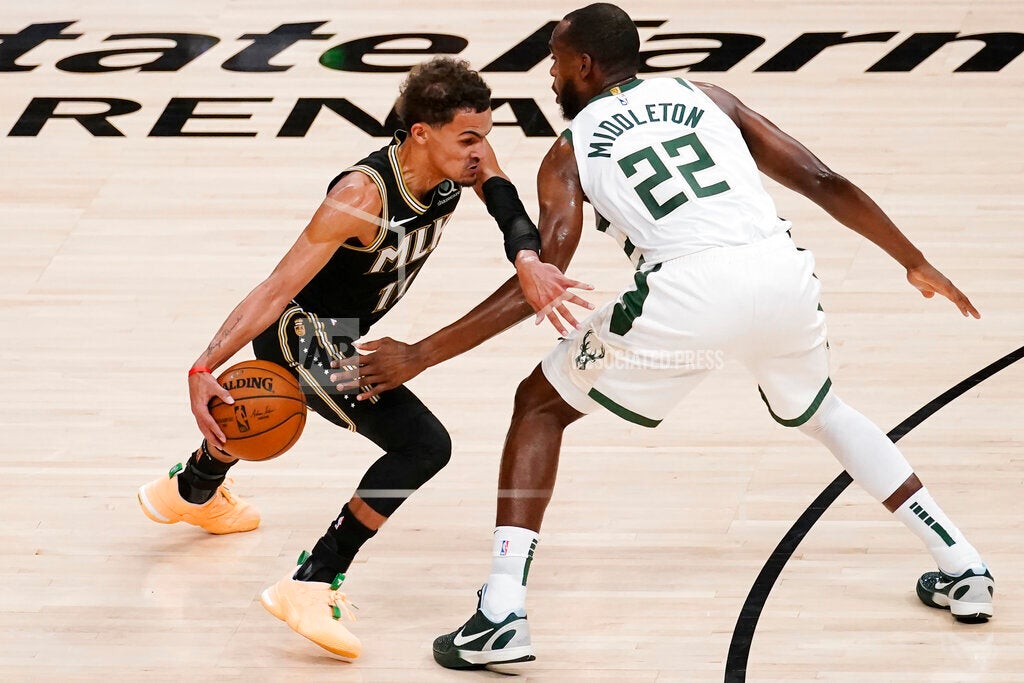 Atlanta Hawks guard Trae Young drives past Milwaukee Bucks forward Khris Middleton