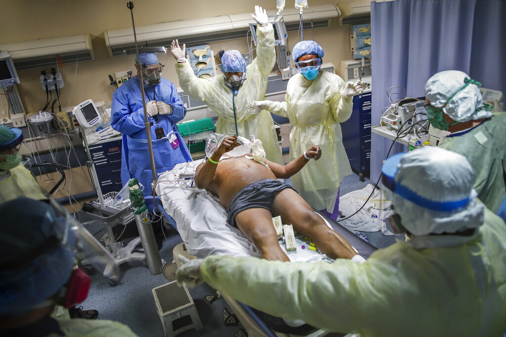 Nurses and doctors defibrillating a COVID-19 patient.