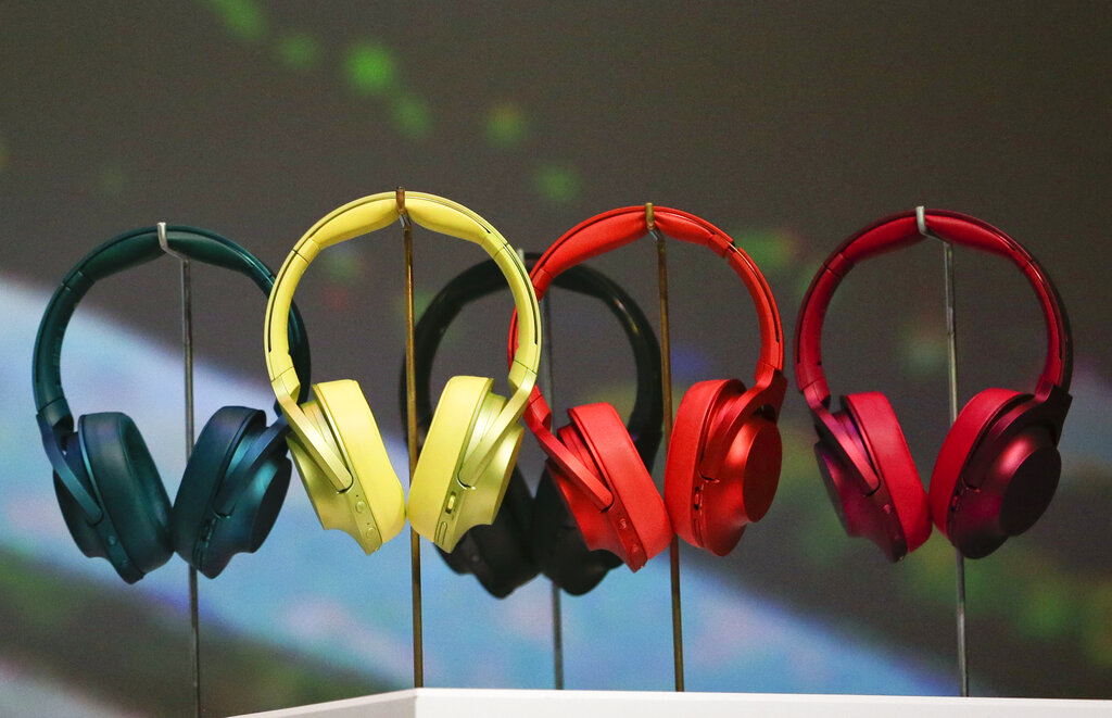 Several over-the-ear headphones in several colors on display in nice lighting.