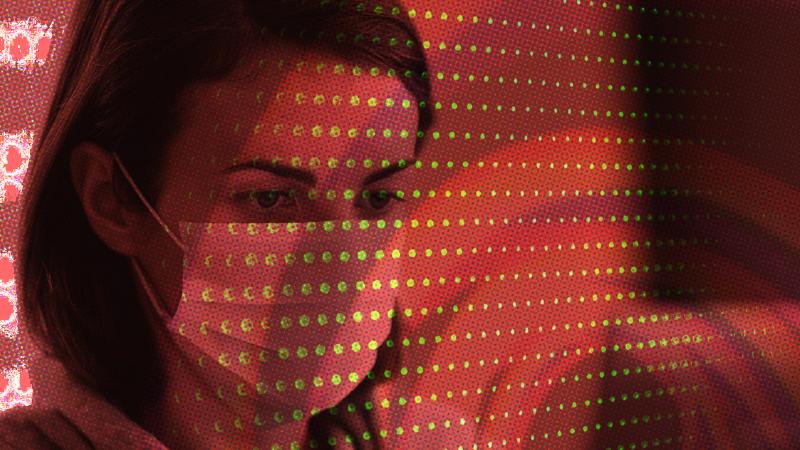 A woman behind screens