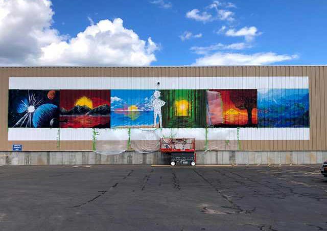 Artist Stephon Kiba Freeman's mural is painted on the side of publisher Worzalla's building in Stevens Point