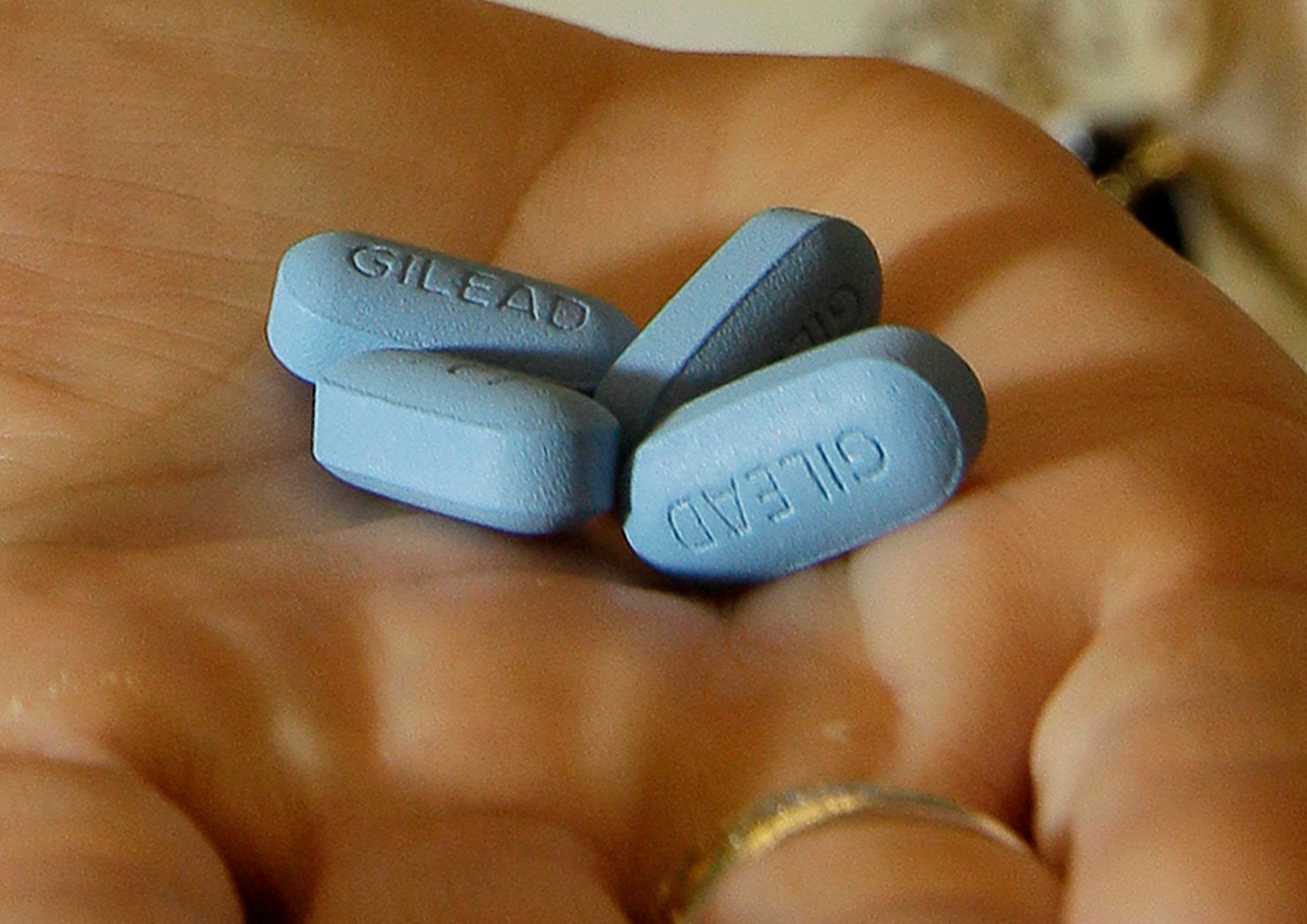 A doctor holds Truvada pills in her office