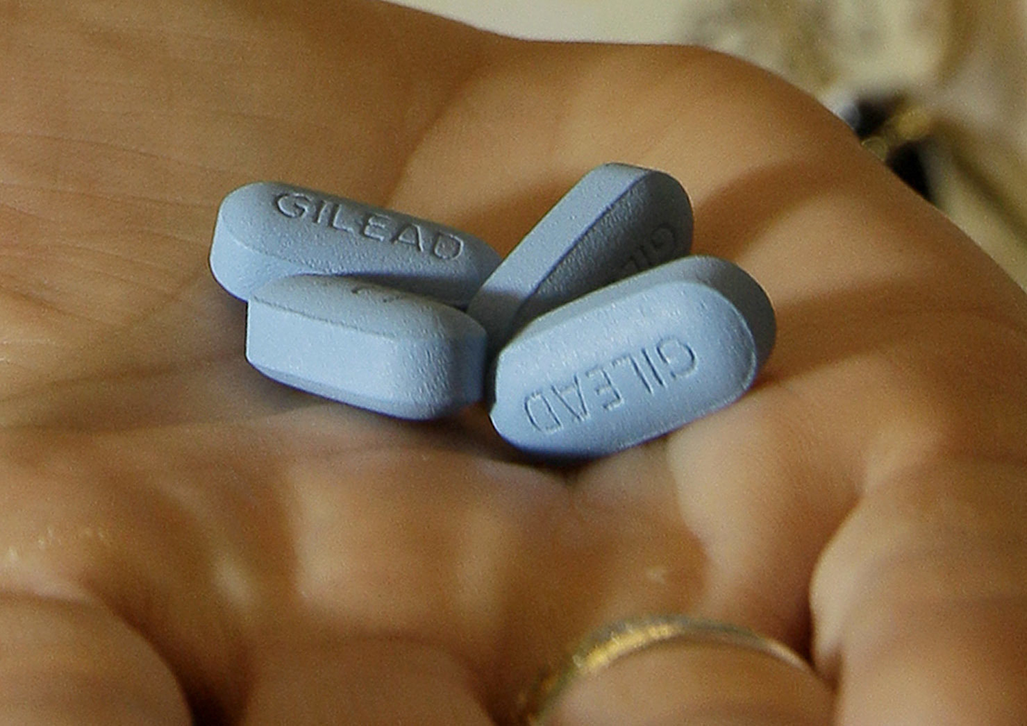 A doctor holds Truvada pills in her office