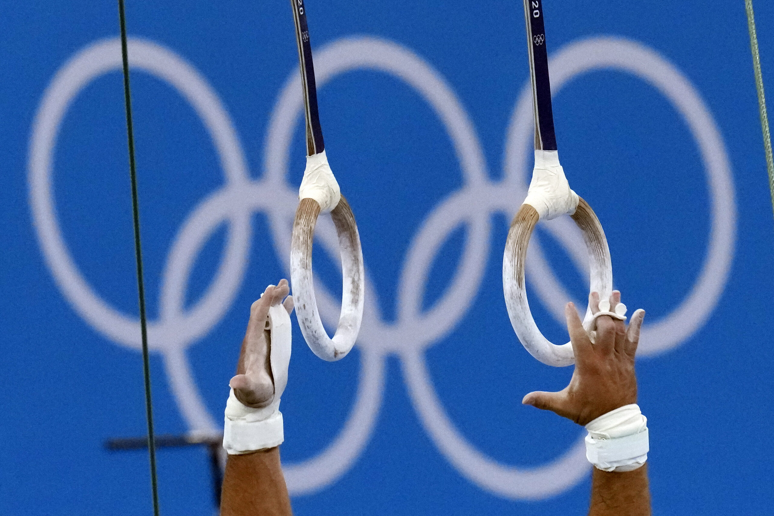 Samir Ait Said, of France, reaches for the rings during competition in artistic gymnastics at the 2020 Summer Olympics