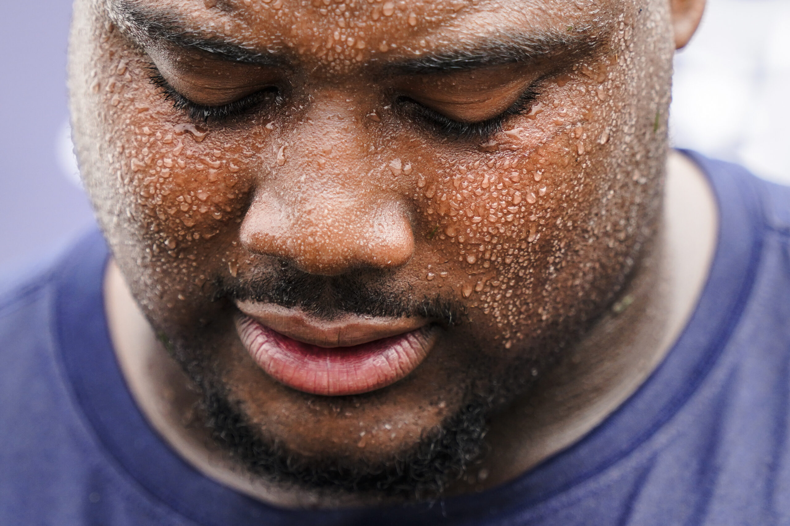 Sweat collects on New England Patriots' Christian Barmore's face