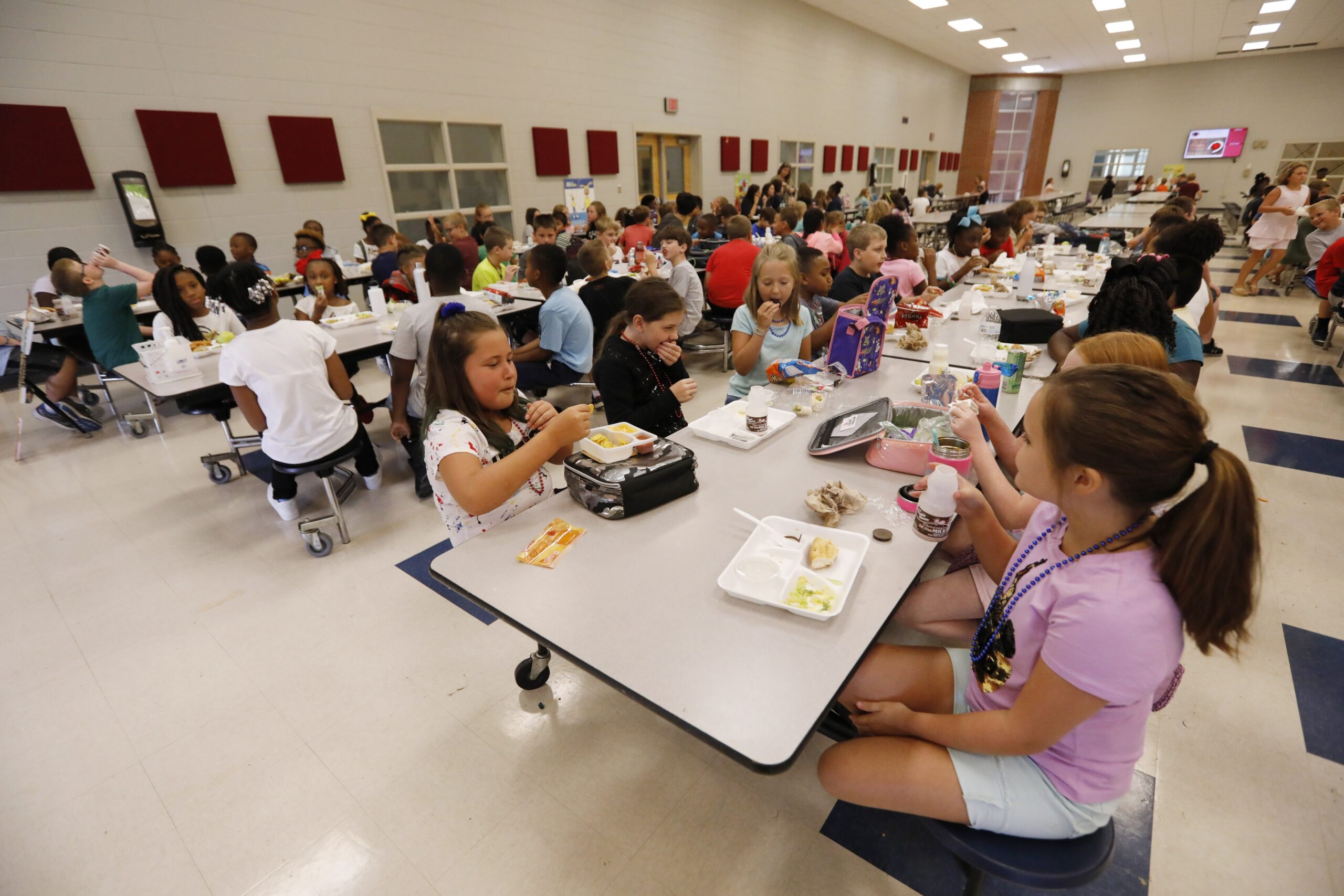 Students eat lunch in a school cafeteria