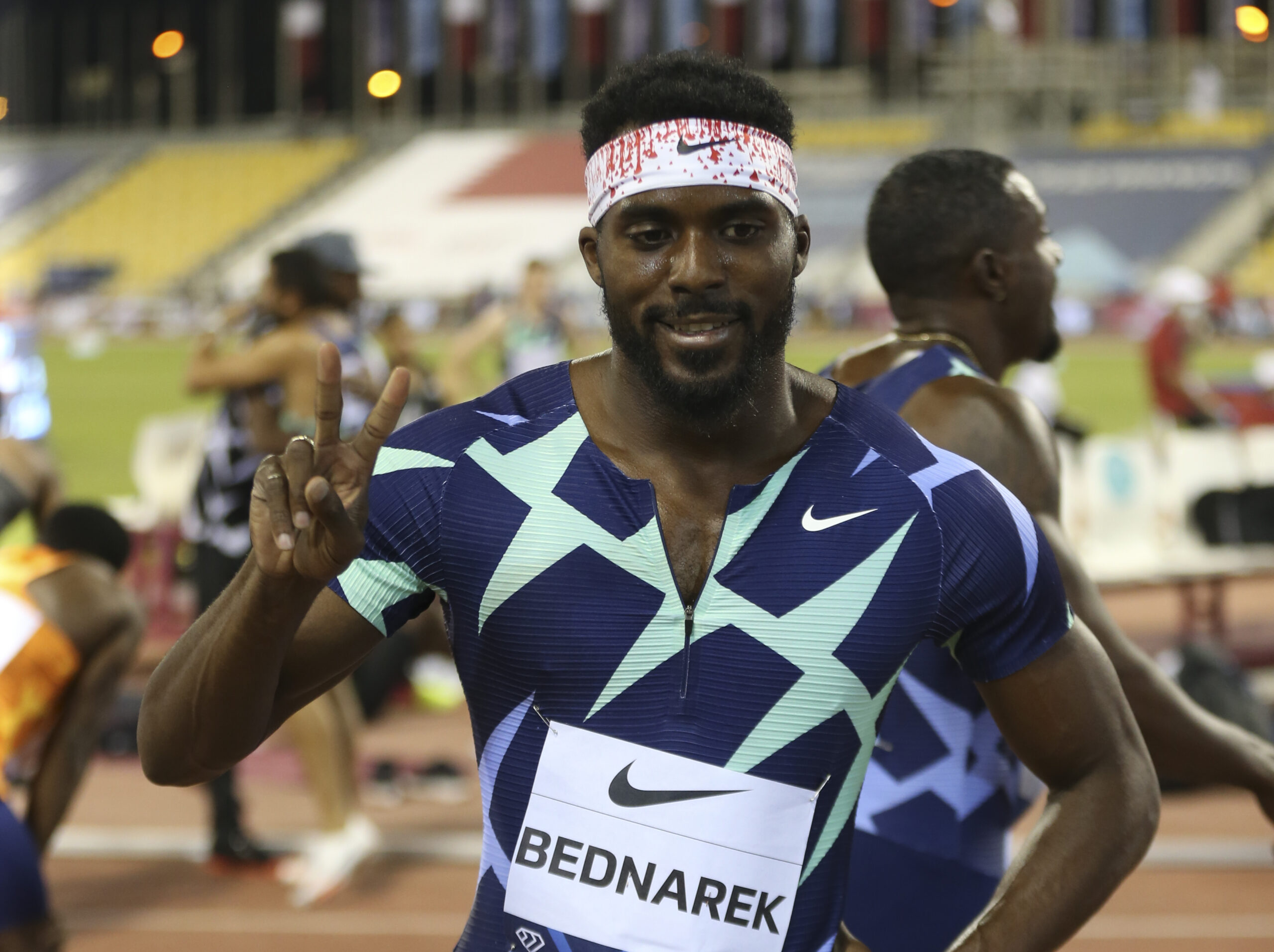 A man gives a peace sign to the camera after winning a sprint