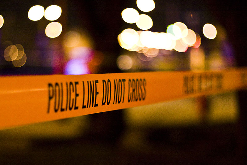Police tape at a nighttime crime scene