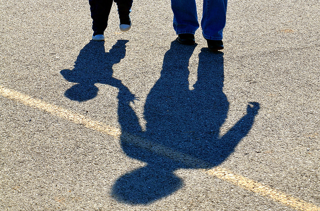 Shadow of two kids on asphalt