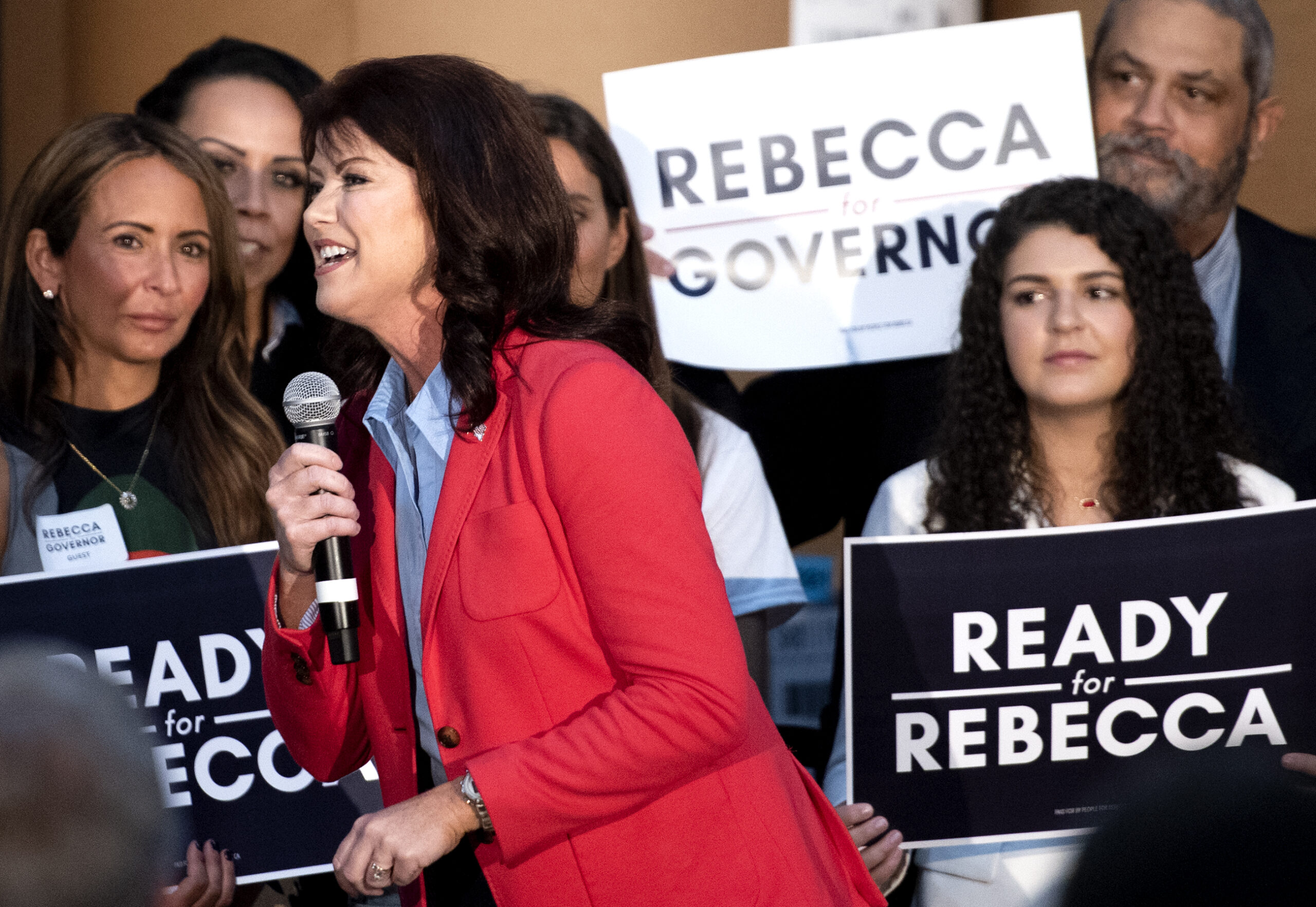 Rebecca Kleefisch speaks into a microphone on stage