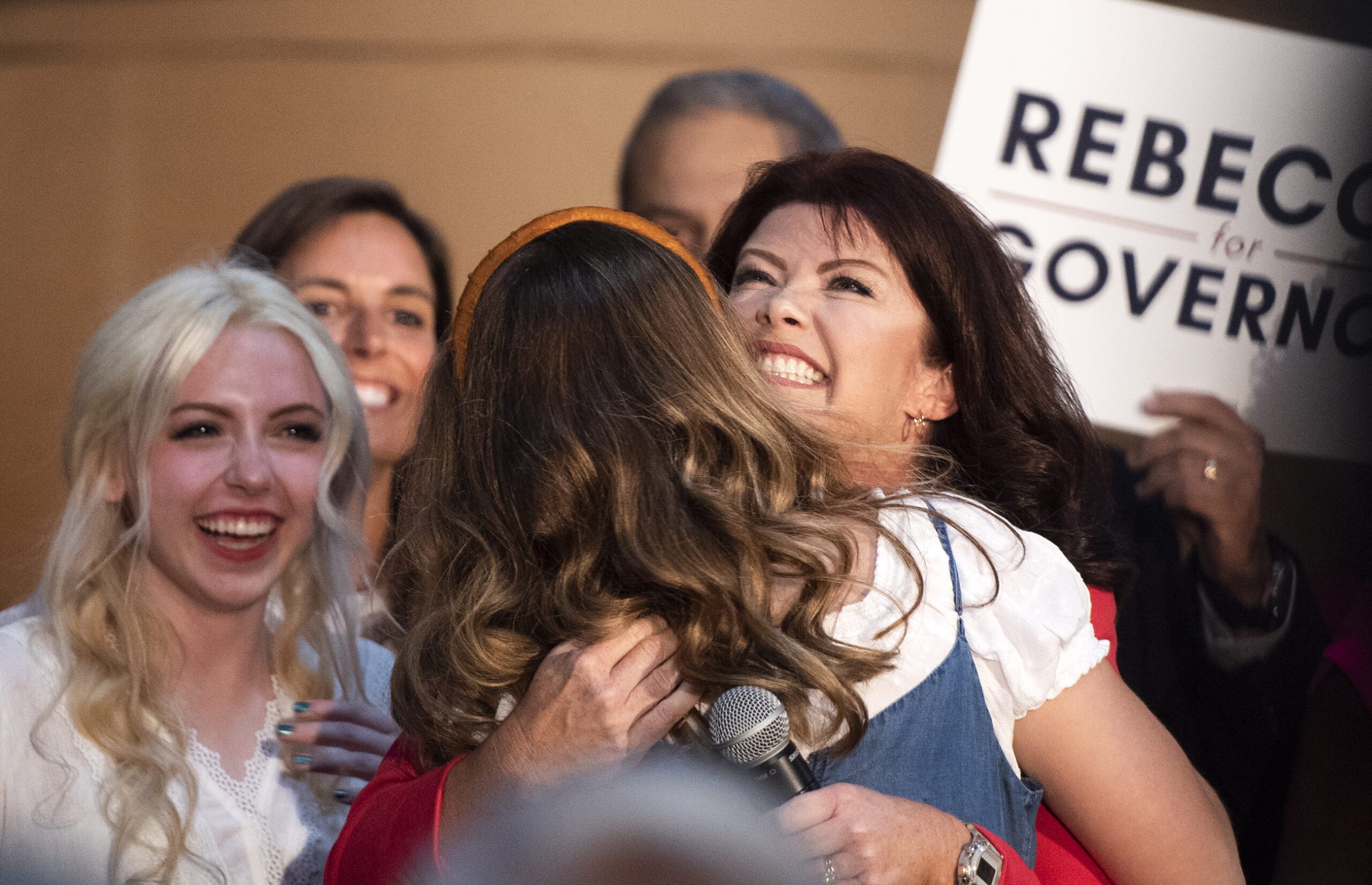 Rebecca Kleefisch smiles as she hugs one of her daughters.
