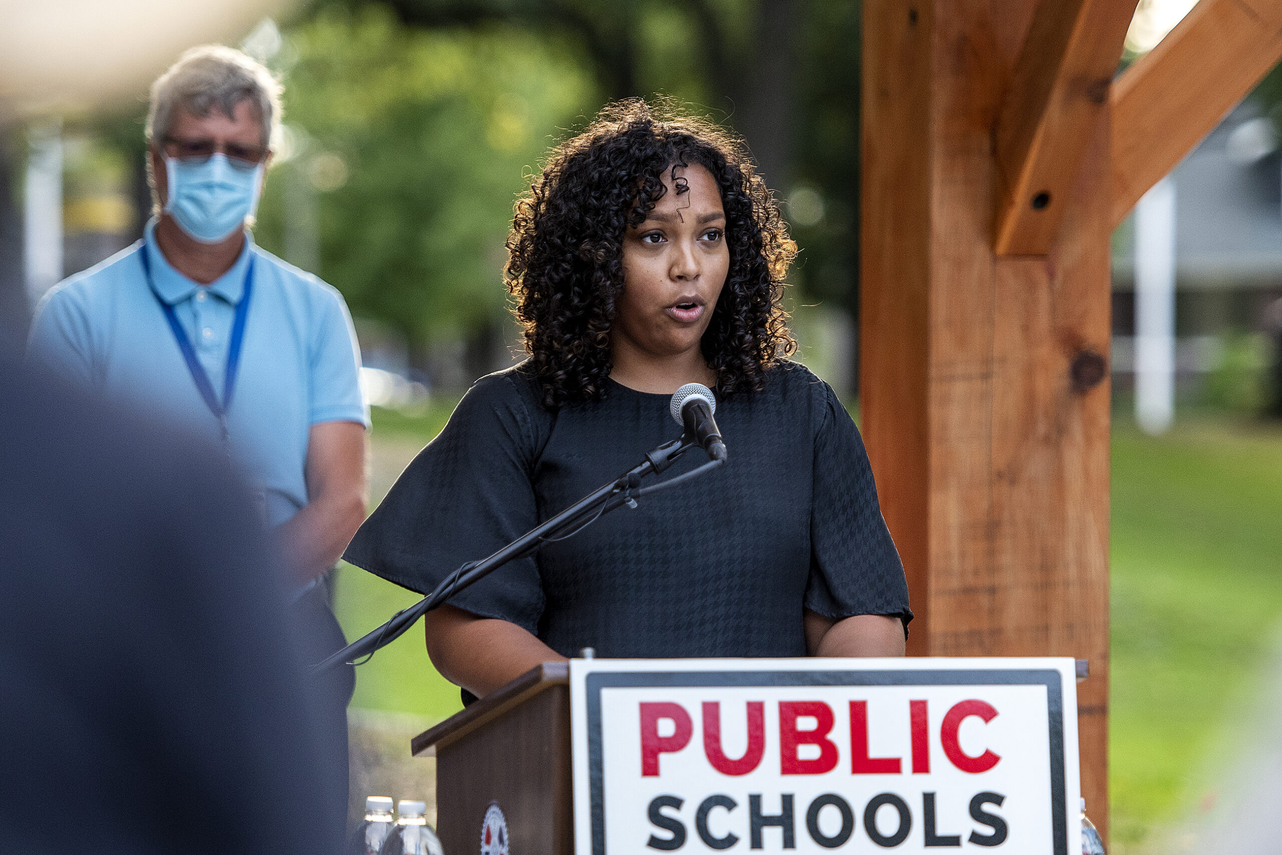 Kendra Koeppen speaks outdoors at a park during a press conference.