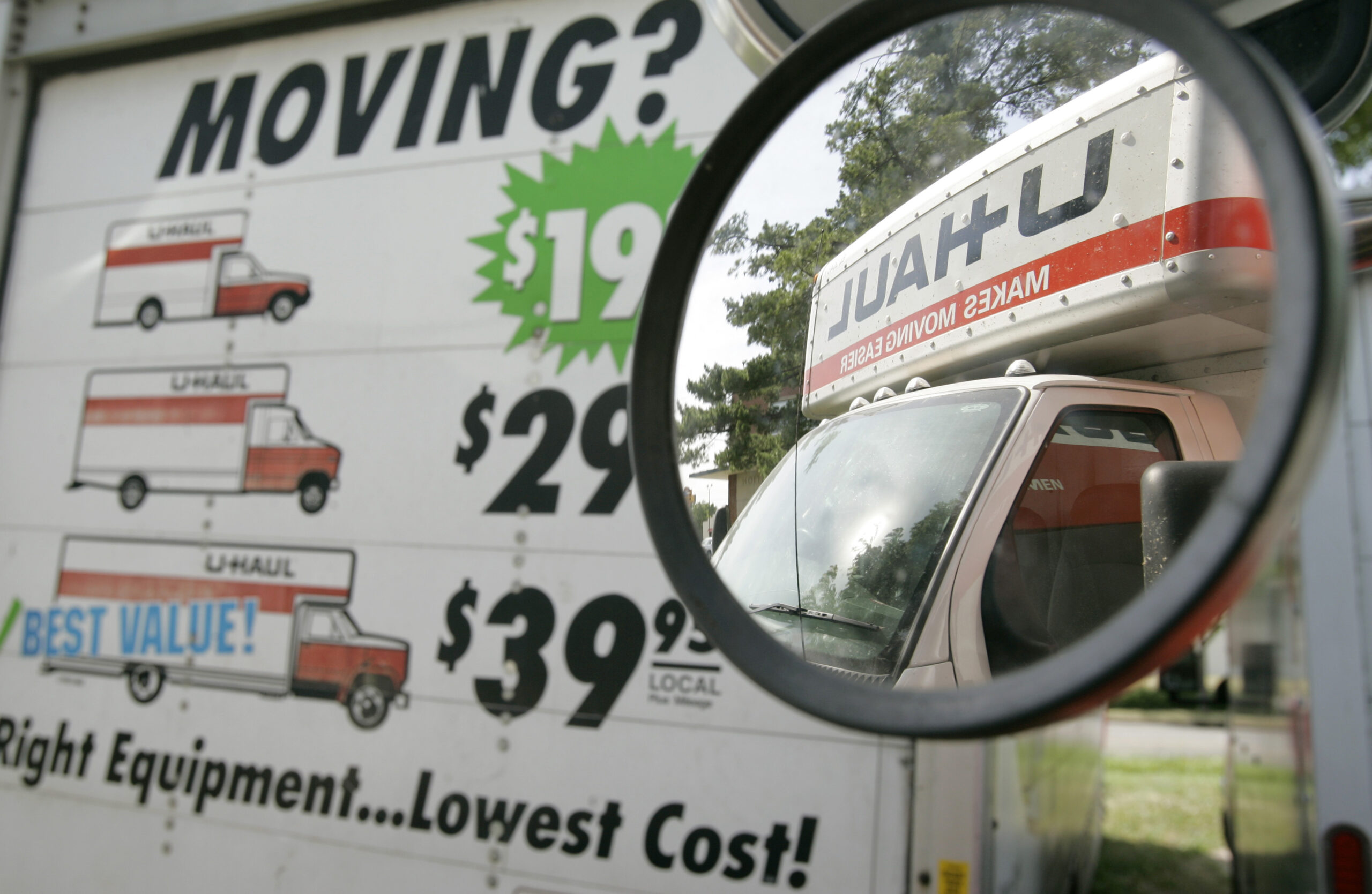 U-Haul truck seen in the side mirror of a another truck