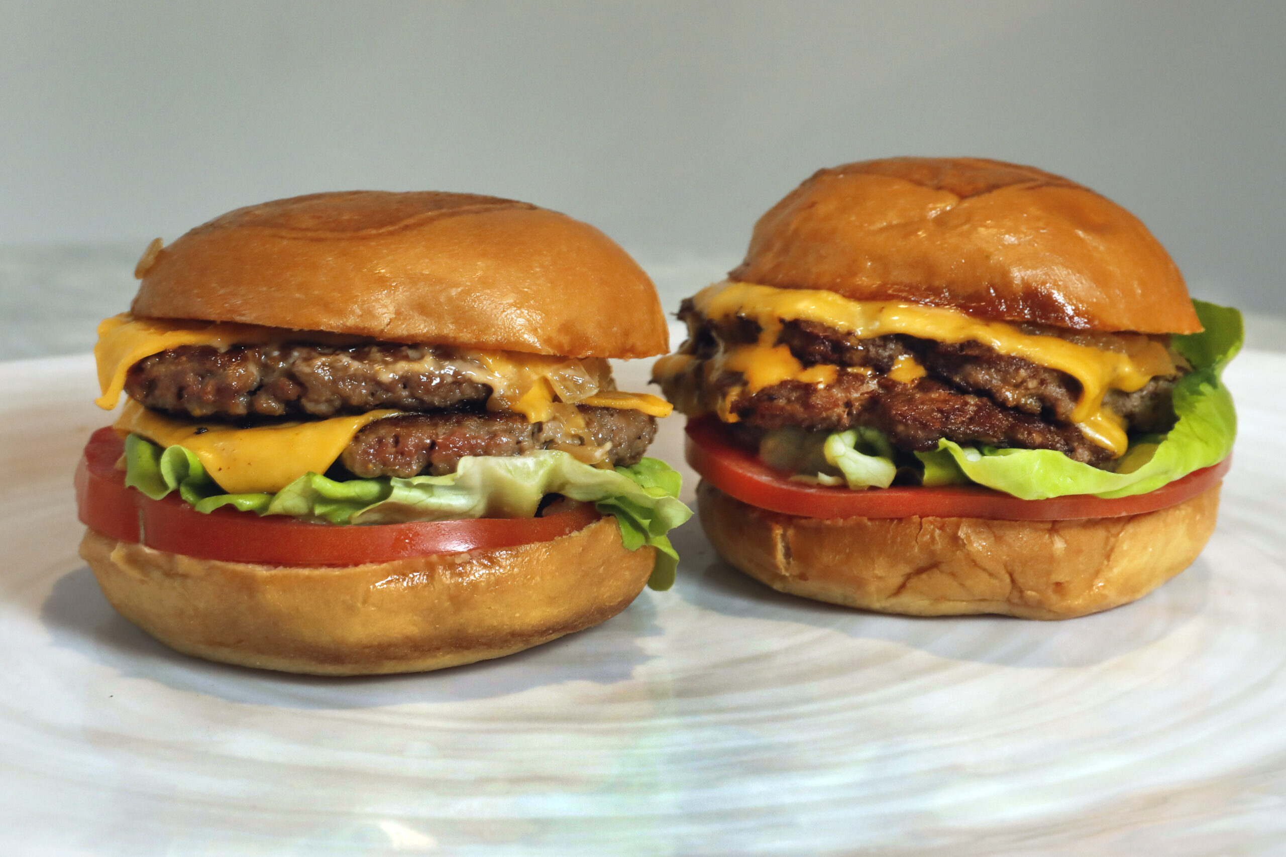 An Original Impossible Burger, left, and a Cali Burger, from Umami Burger, are shown in this photo.